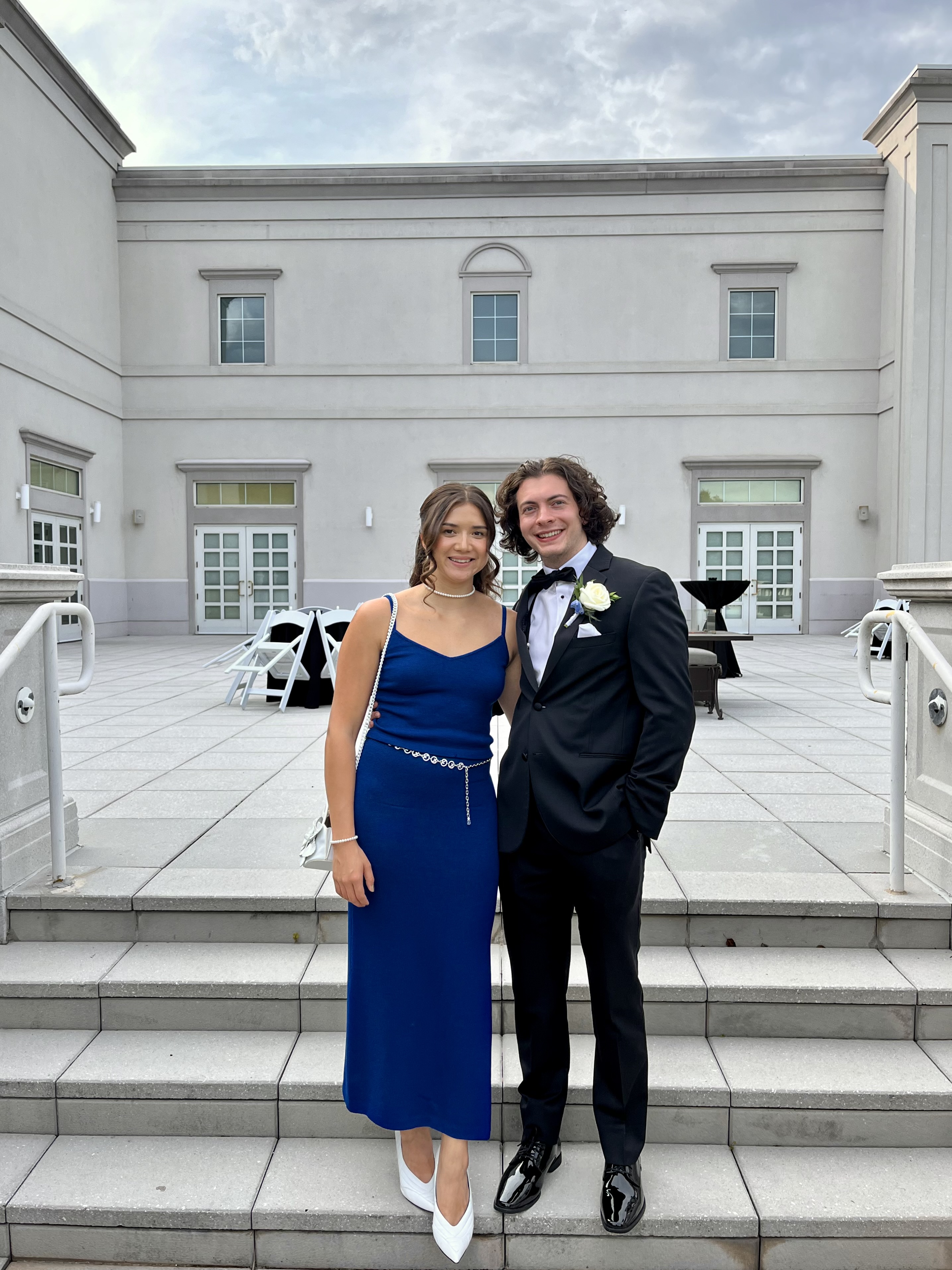 Keenan Yates ’24 and Thomas Obiedzinski ’24 pose for a photo together on steps outside in formal wear