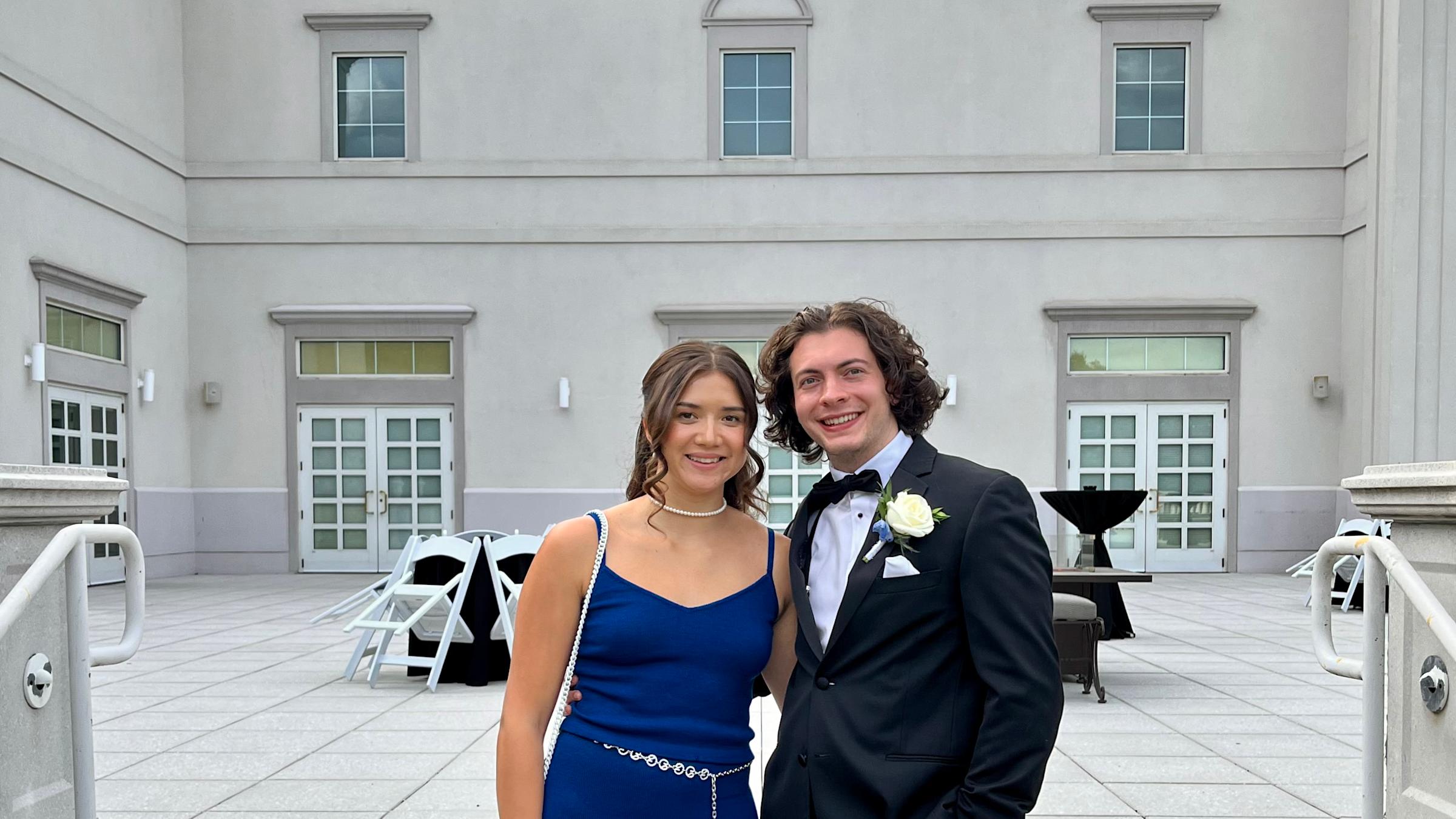 Keenan Yates ’24 and Thomas Obiedzinski ’24 pose for a photo together on steps outside in formal wear