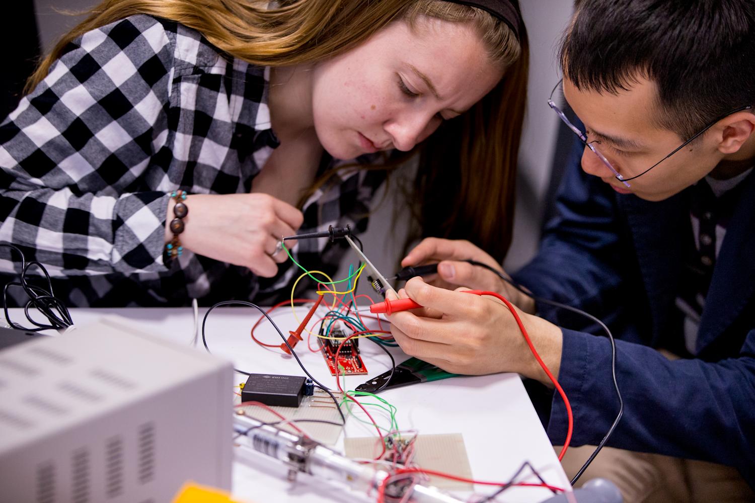 Two students working on wiring