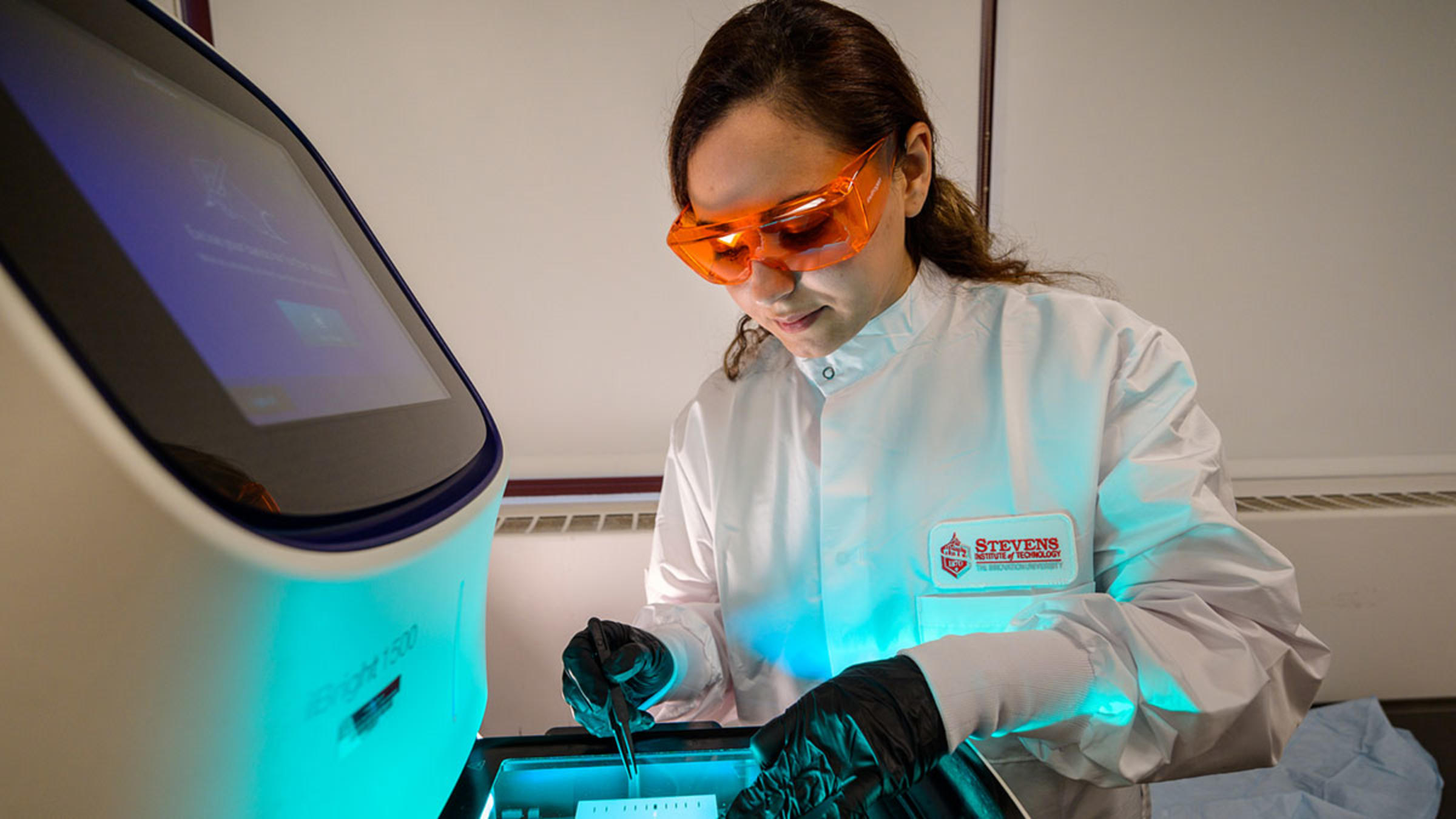 Student using a tablet device in a biology lab.