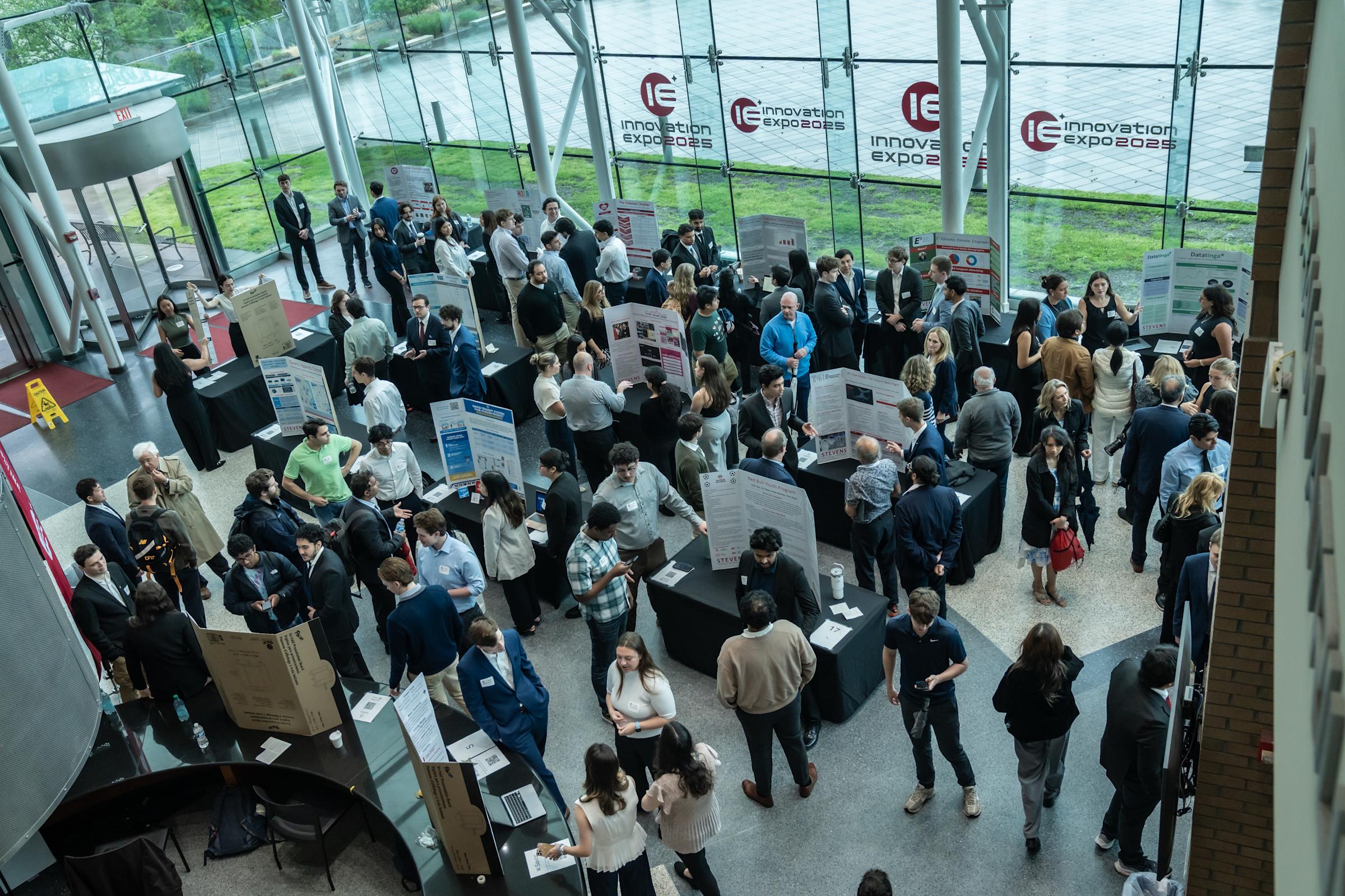 Overhead view of the Babbio Center atrium with senior design projects on display.
