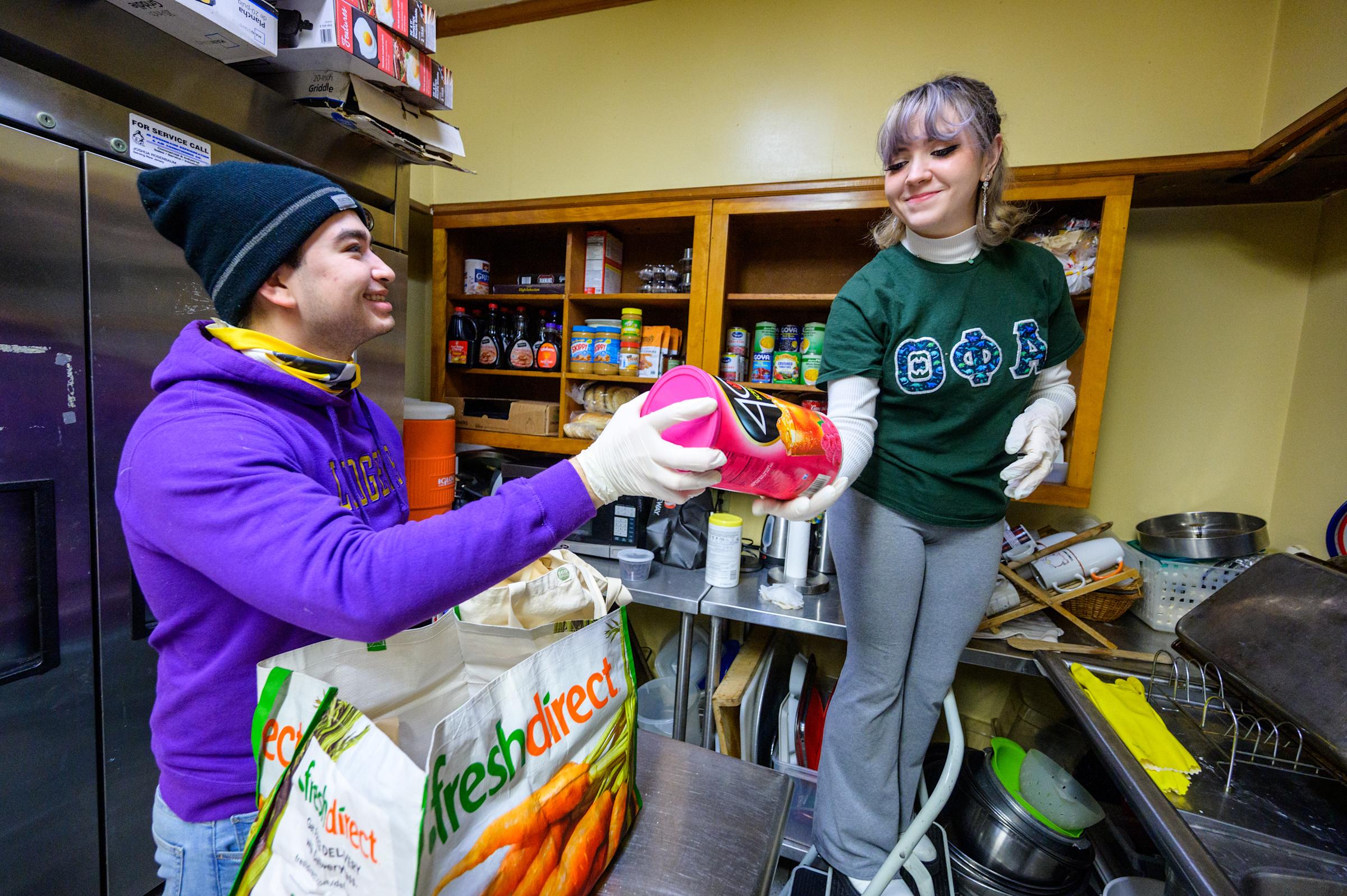 Students organizing canned food products at the Lunchtime Ministries