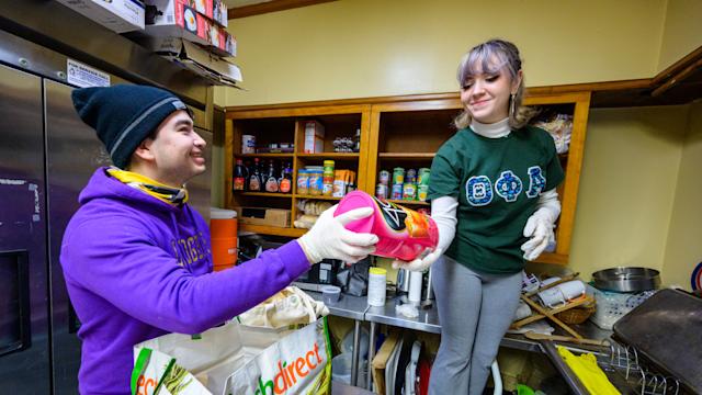 Students organizing canned food products at the Lunchtime Ministries
