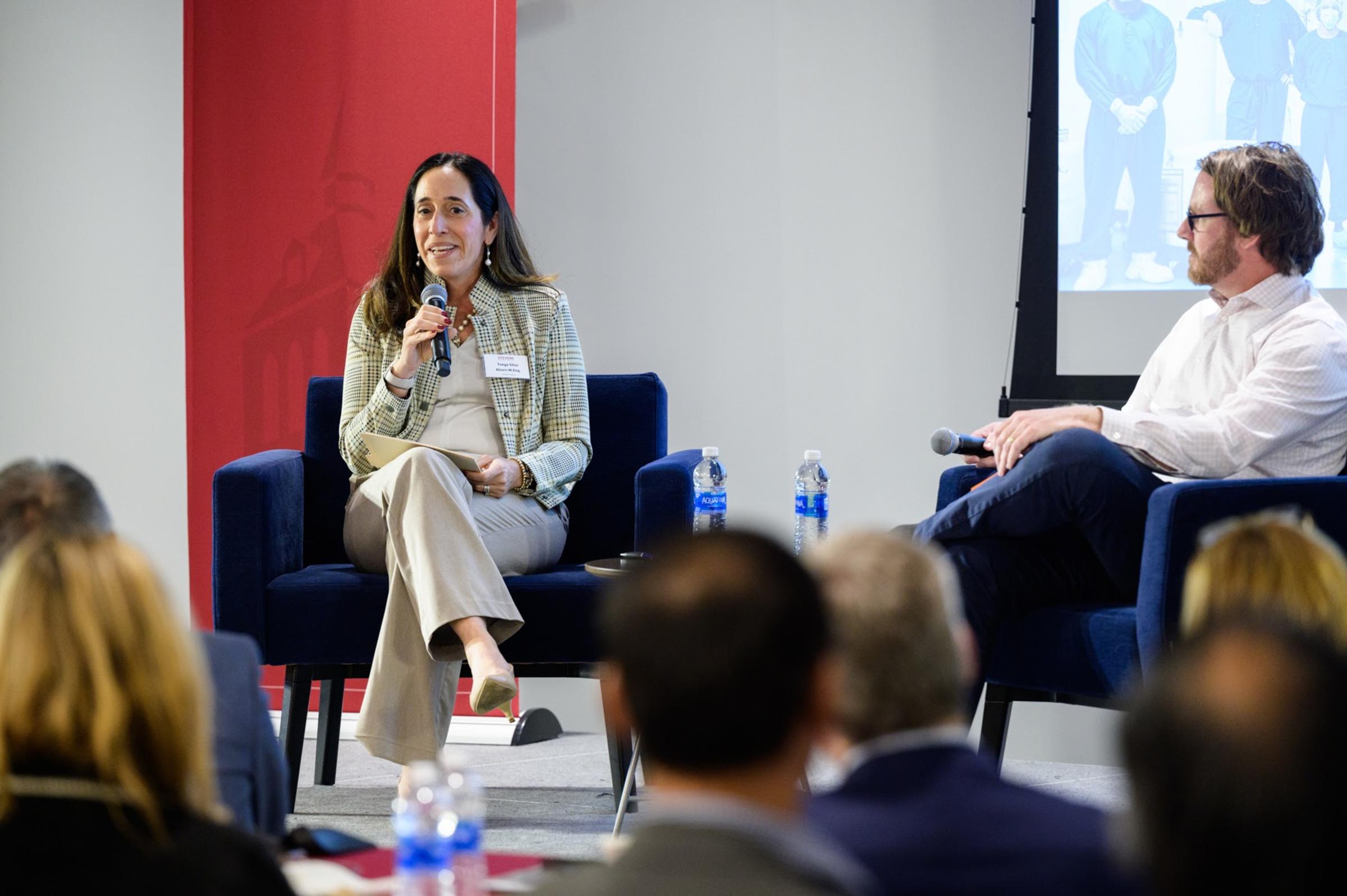Stevens alumna Tanya Alcorn on stage with corporation relations director Greg Townsend at CHI event