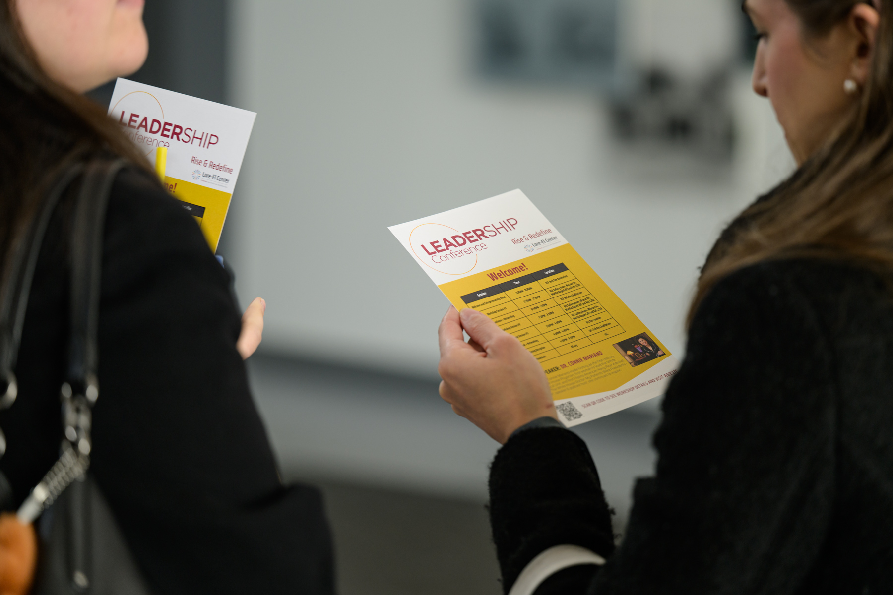 Conference attendees viewing the event agenda