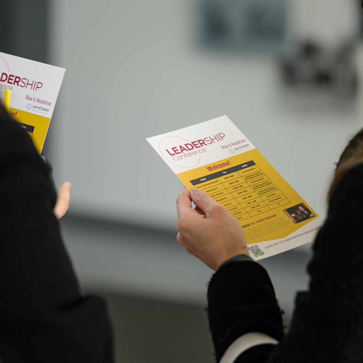 Conference attendees viewing the event agenda