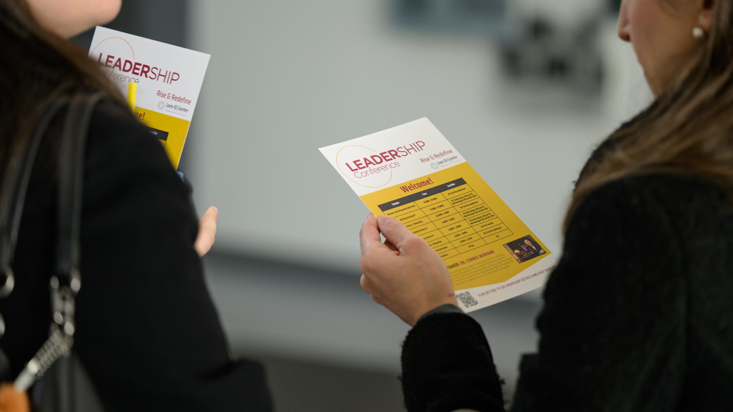 Conference attendees viewing the event agenda