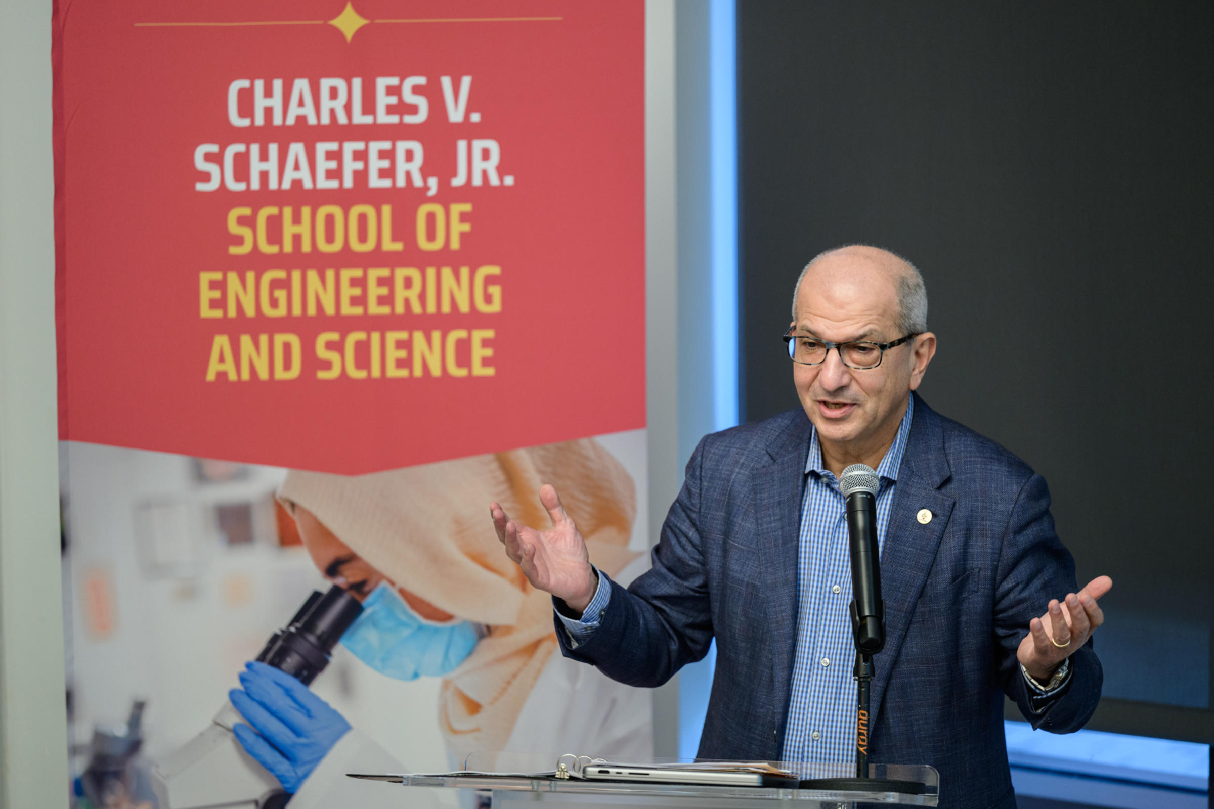 Stevens president Nariman Farvardin speaks from behind a podium.