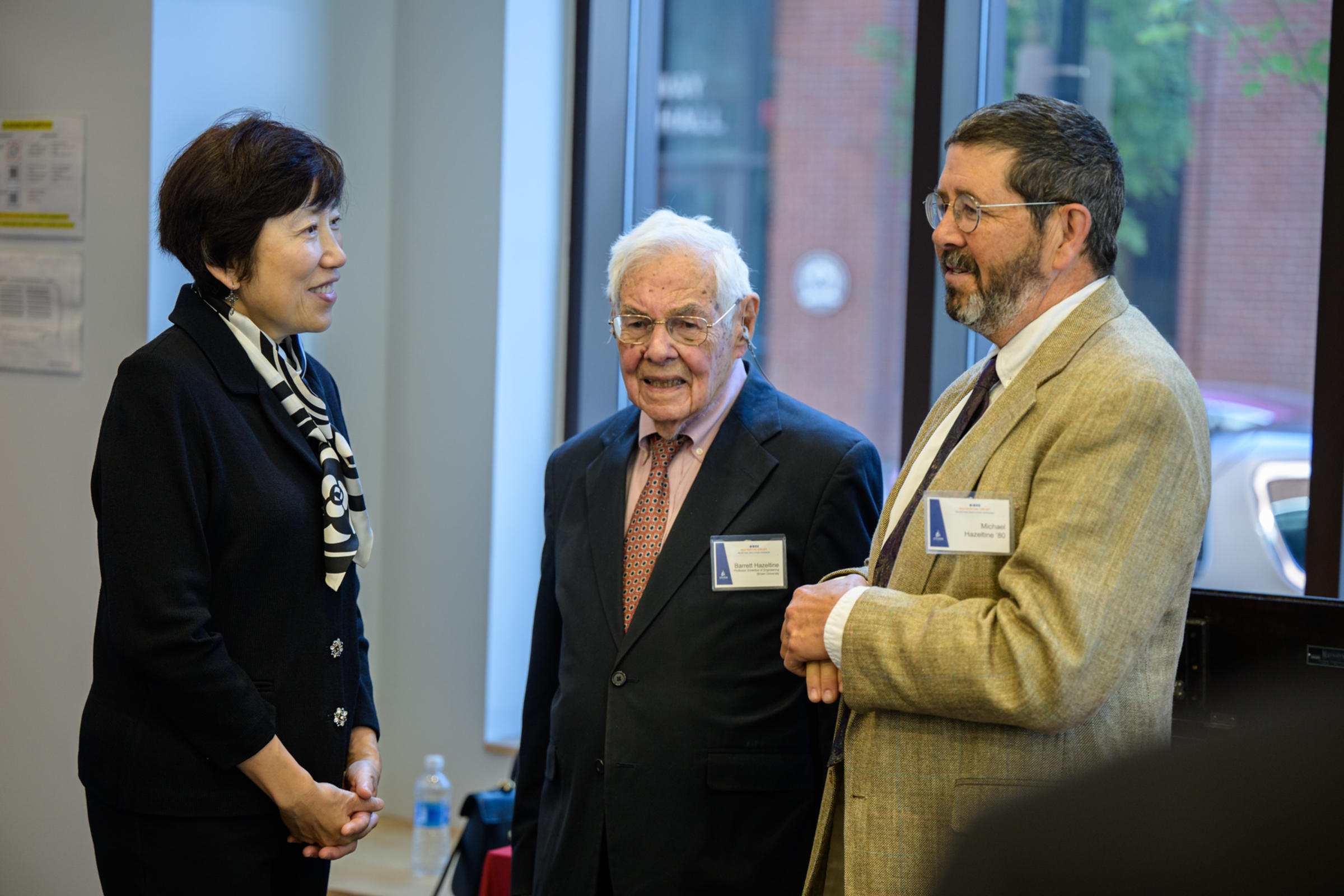 From left to right, Jean Zu speaks with Barrett Hazeltine and Michael Hazeltine.