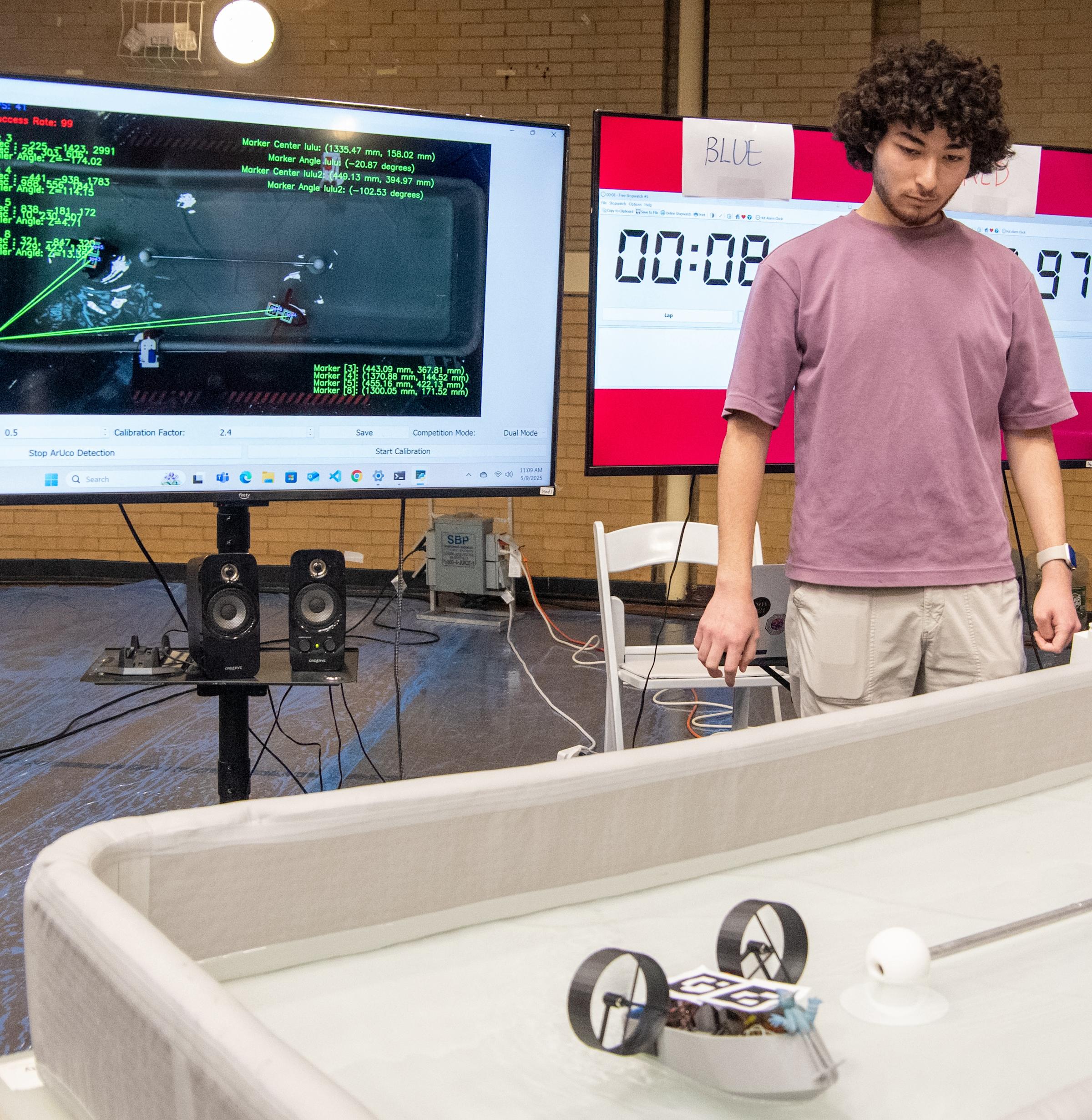 student watches autonomous craft during 2025 robotics competition