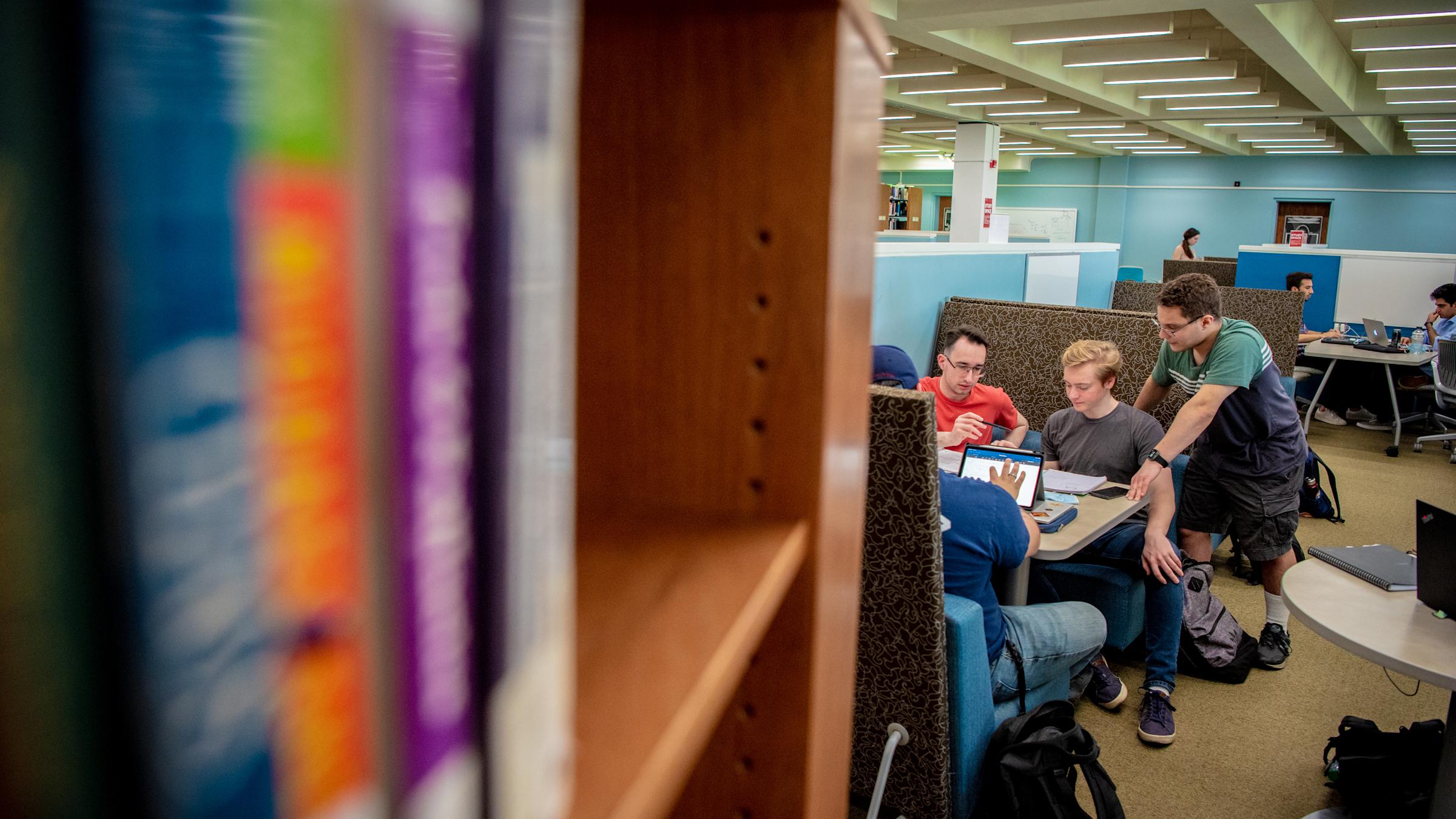 Students working at a table in the library.