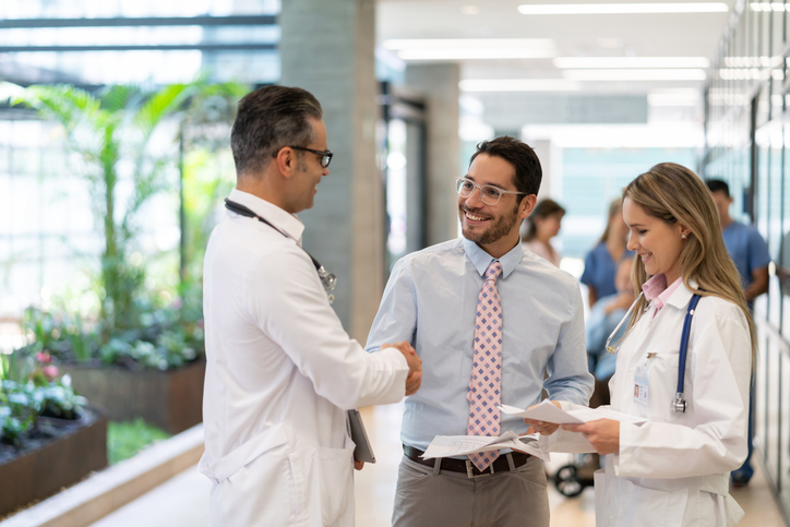 businessman shaking hand with healthcare worker