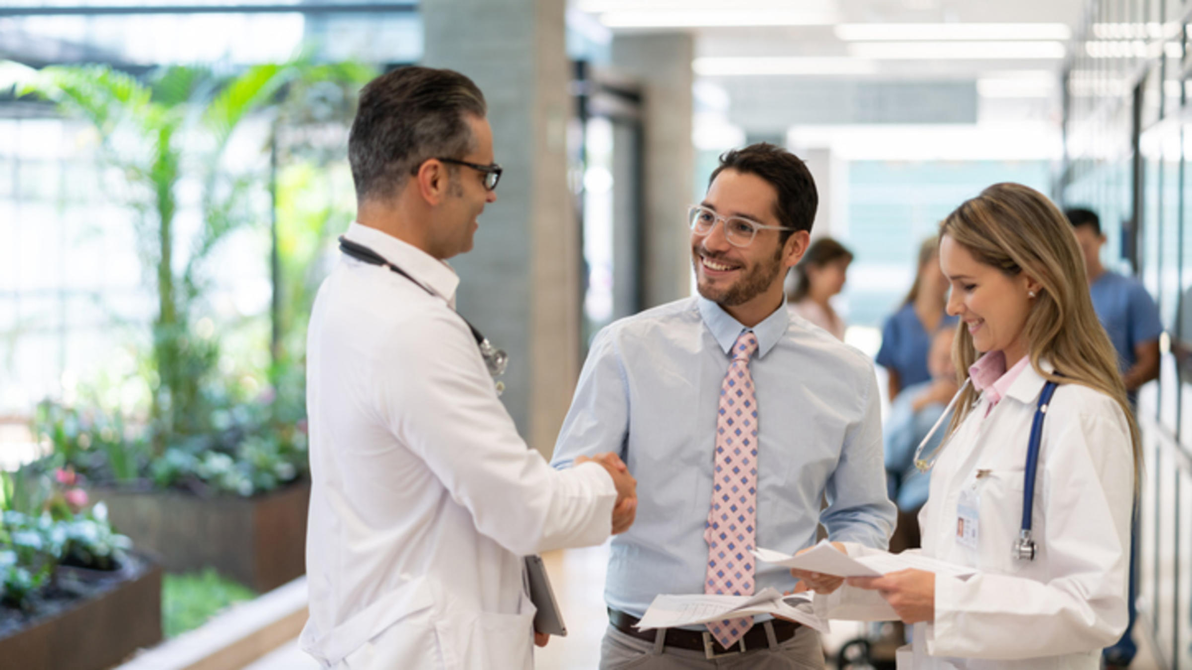 businessman shaking hand with healthcare worker