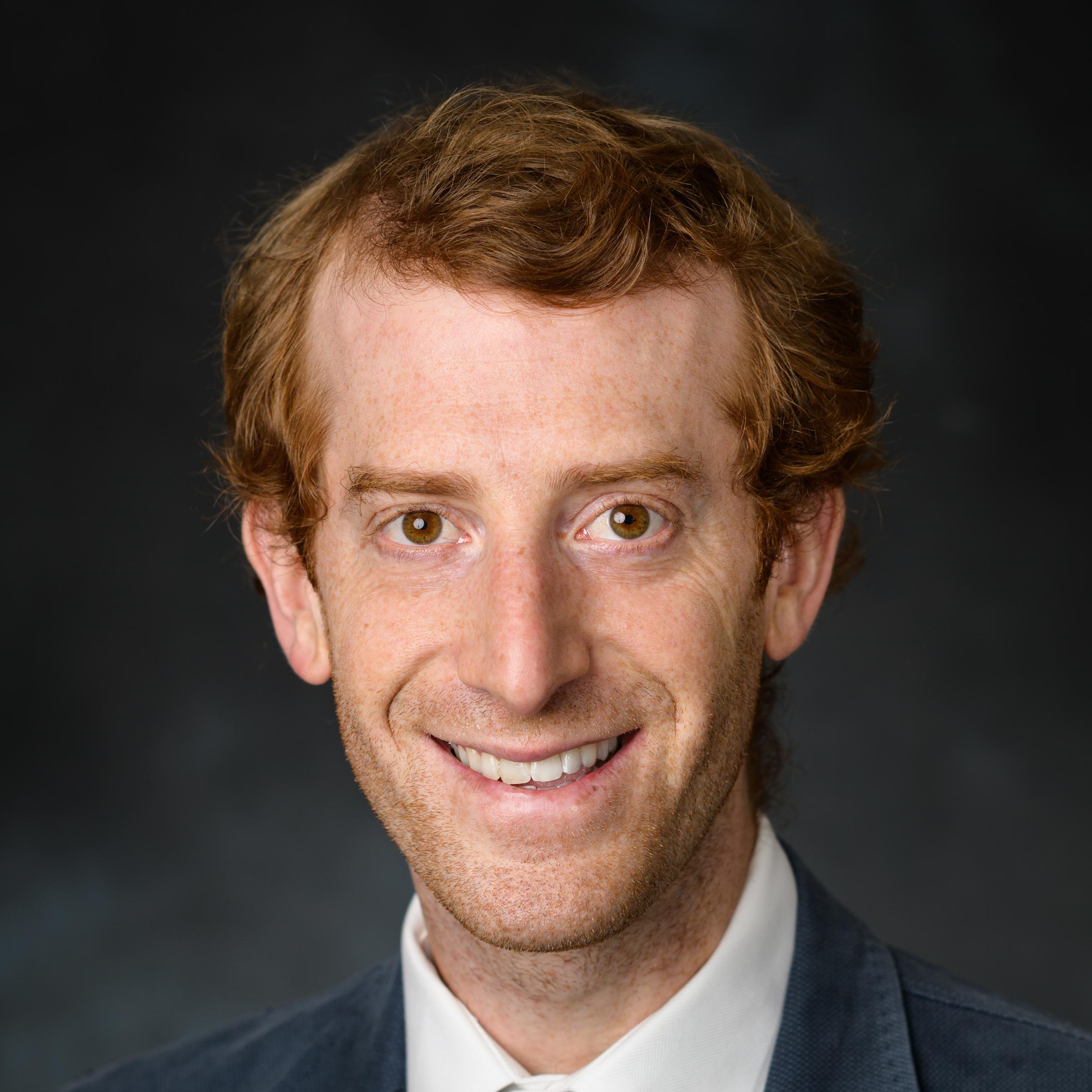 A professional headshot of Jason Rabinovitch dressed in a suit.