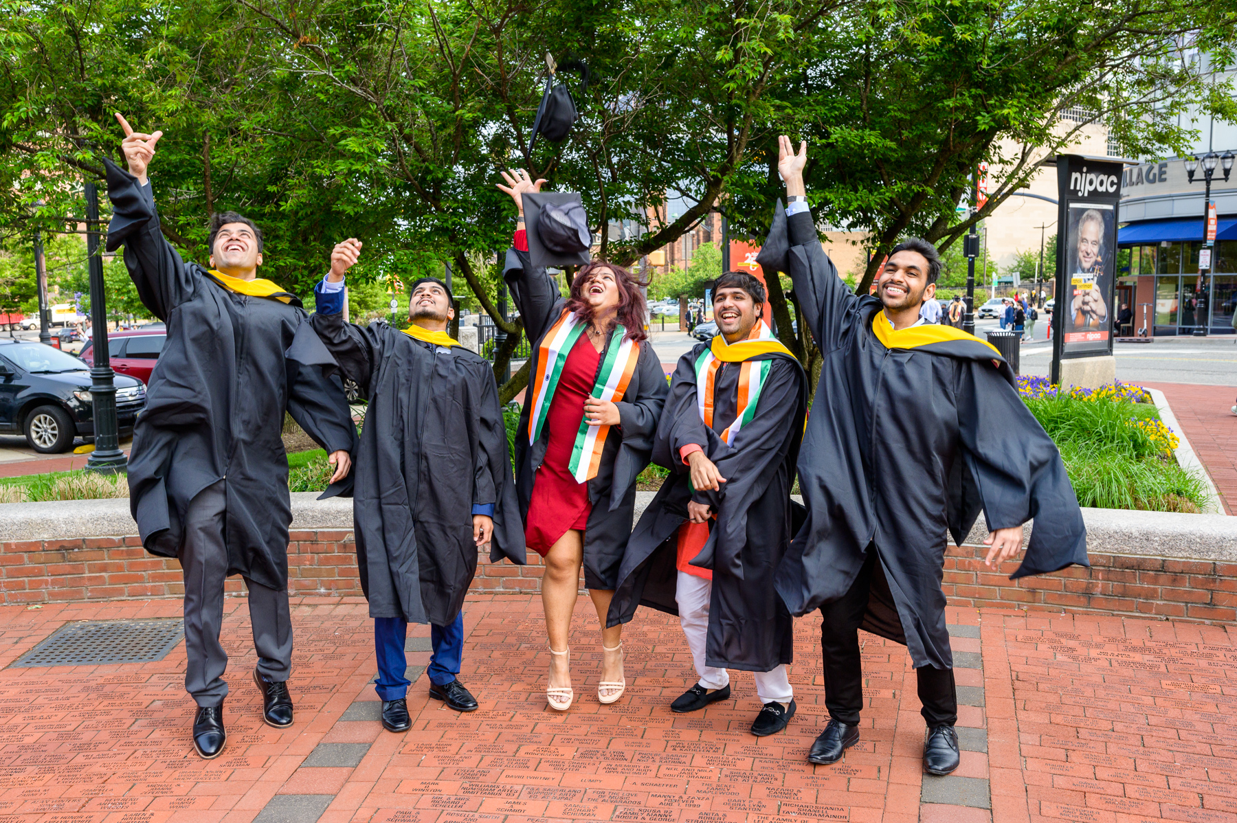 Group of graduates toss their caps into the air to celebrate graduation