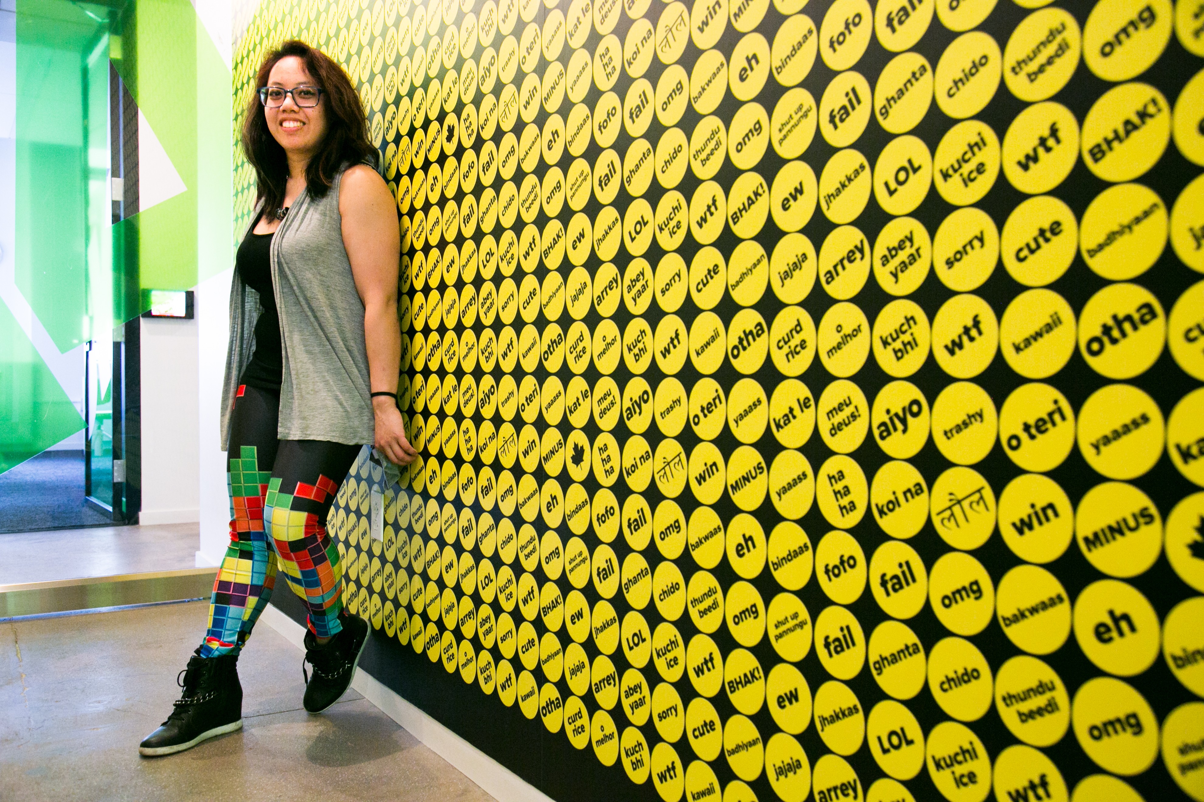 Caroline Amaba standing against a wall at Buzzfeed headquarters 