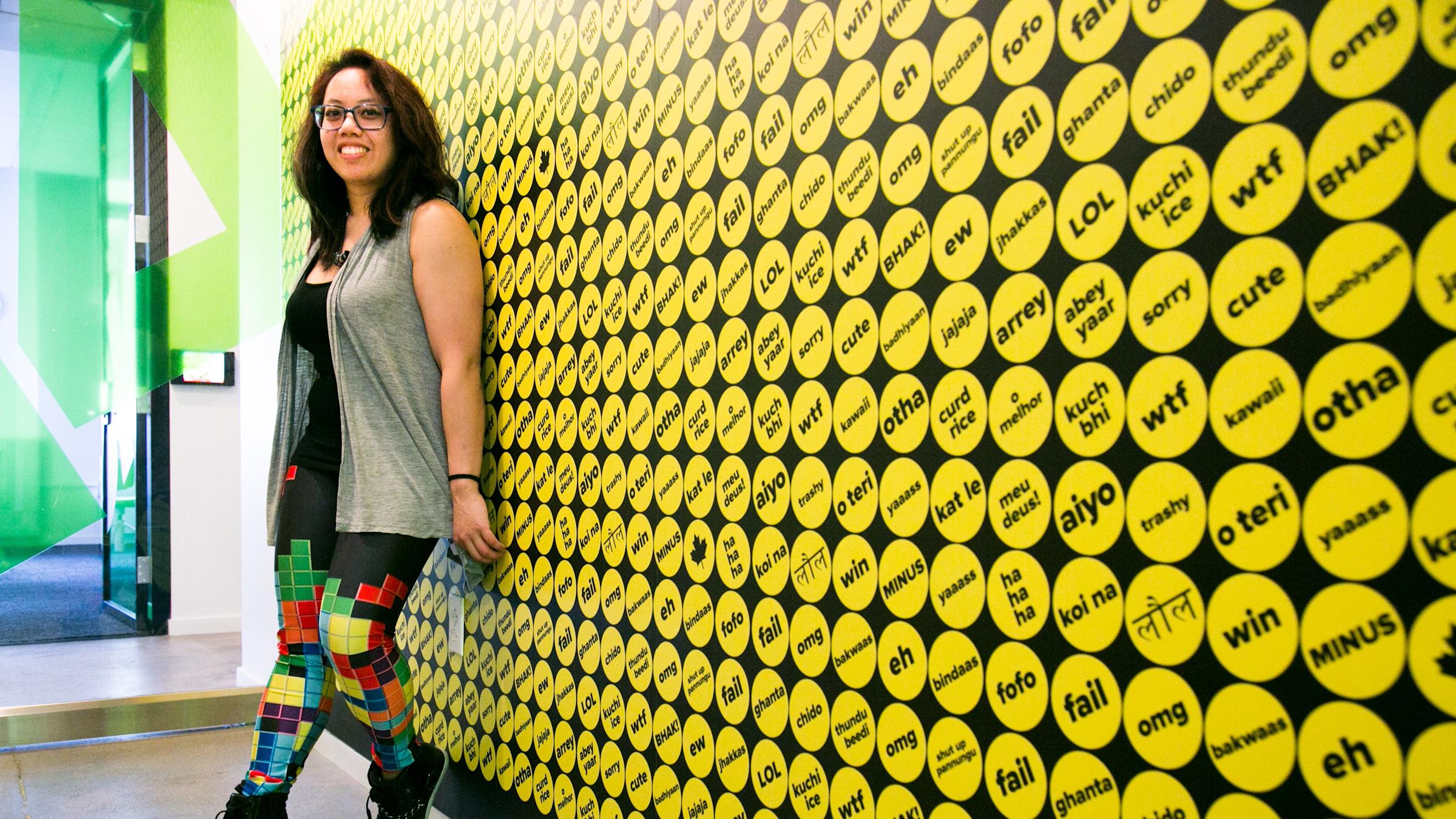Caroline Amaba standing against a wall at Buzzfeed headquarters
