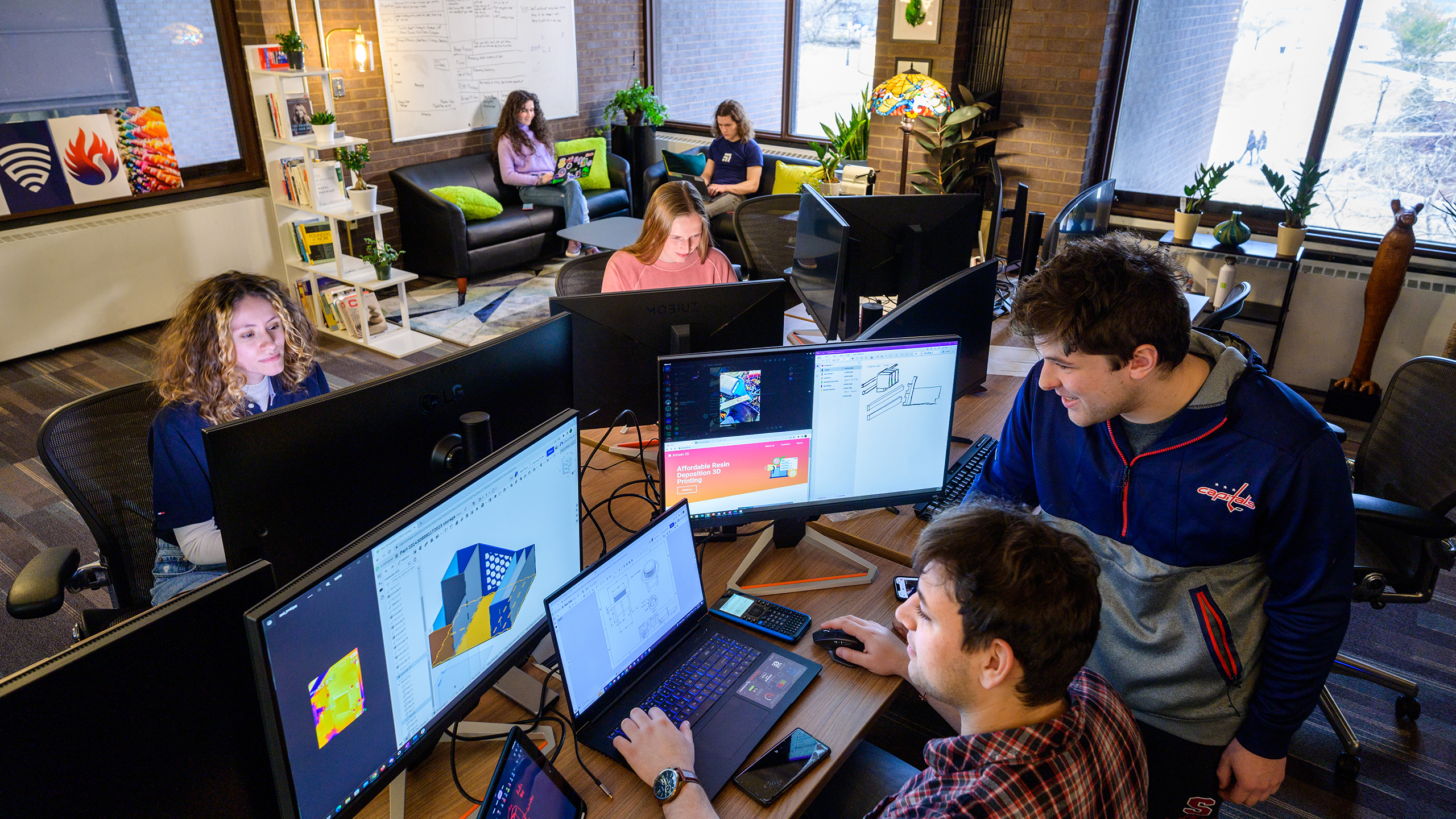 Students gather to collaborate and work on computers as part of the iSTEM program