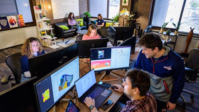 Students gather to collaborate and work on computers as part of the iSTEM program