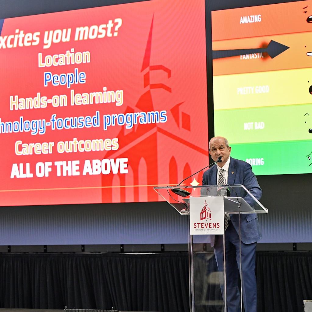 Stevens President Nariman Farvardin stands in front of a screen