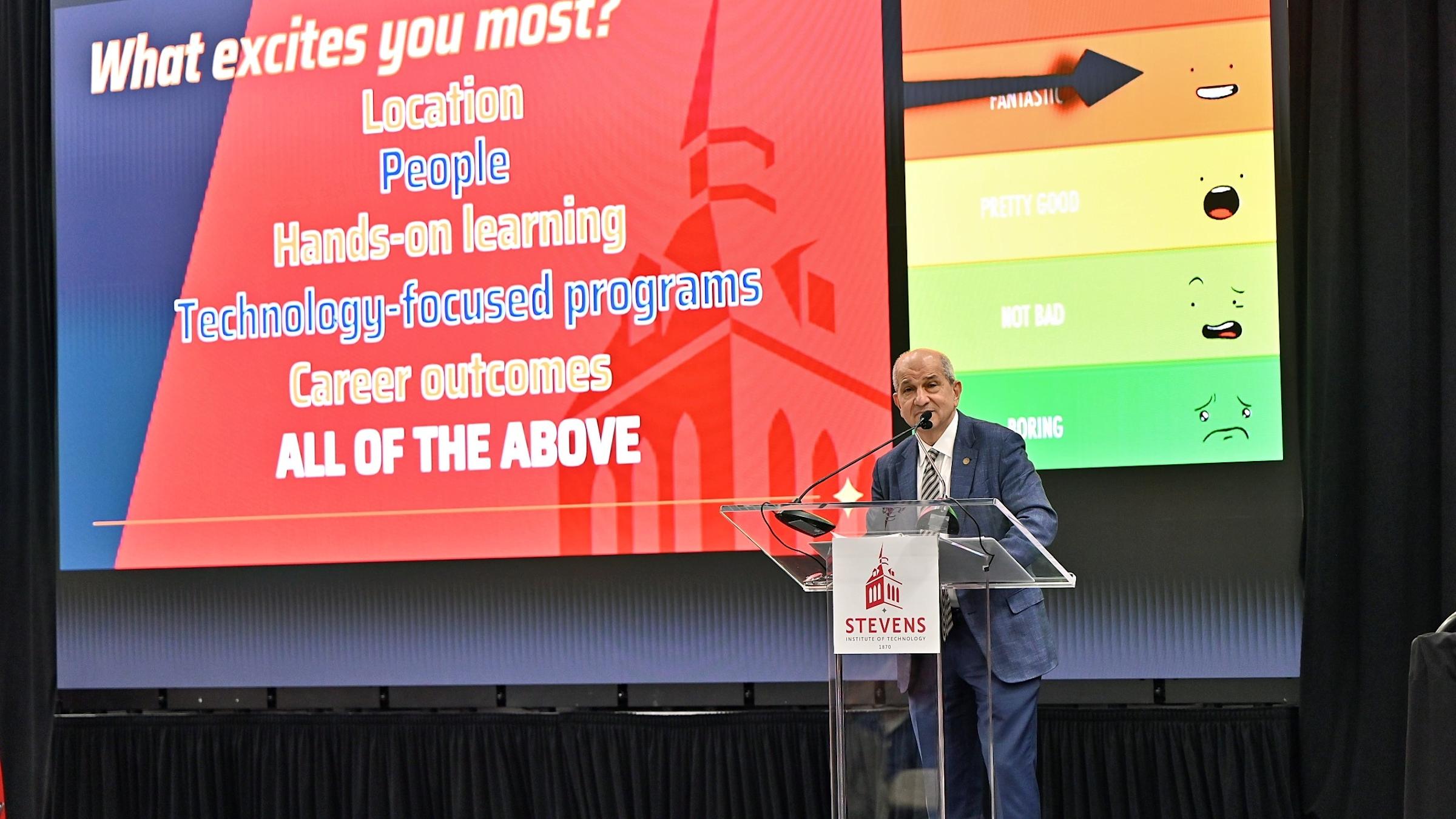Stevens President Nariman Farvardin stands in front of a screen