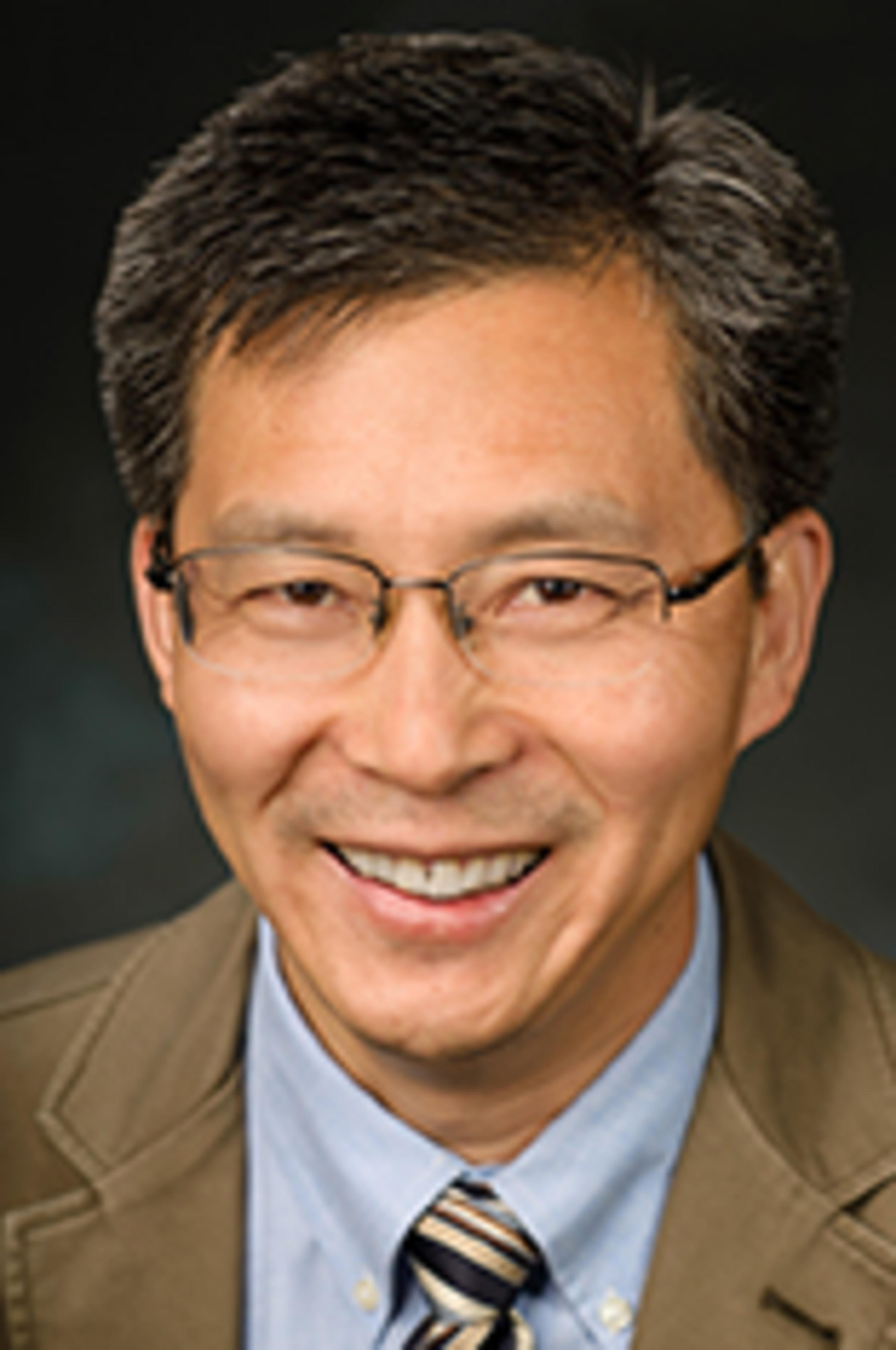 Headshot of Dr. Steve Yang against a black backdrop.