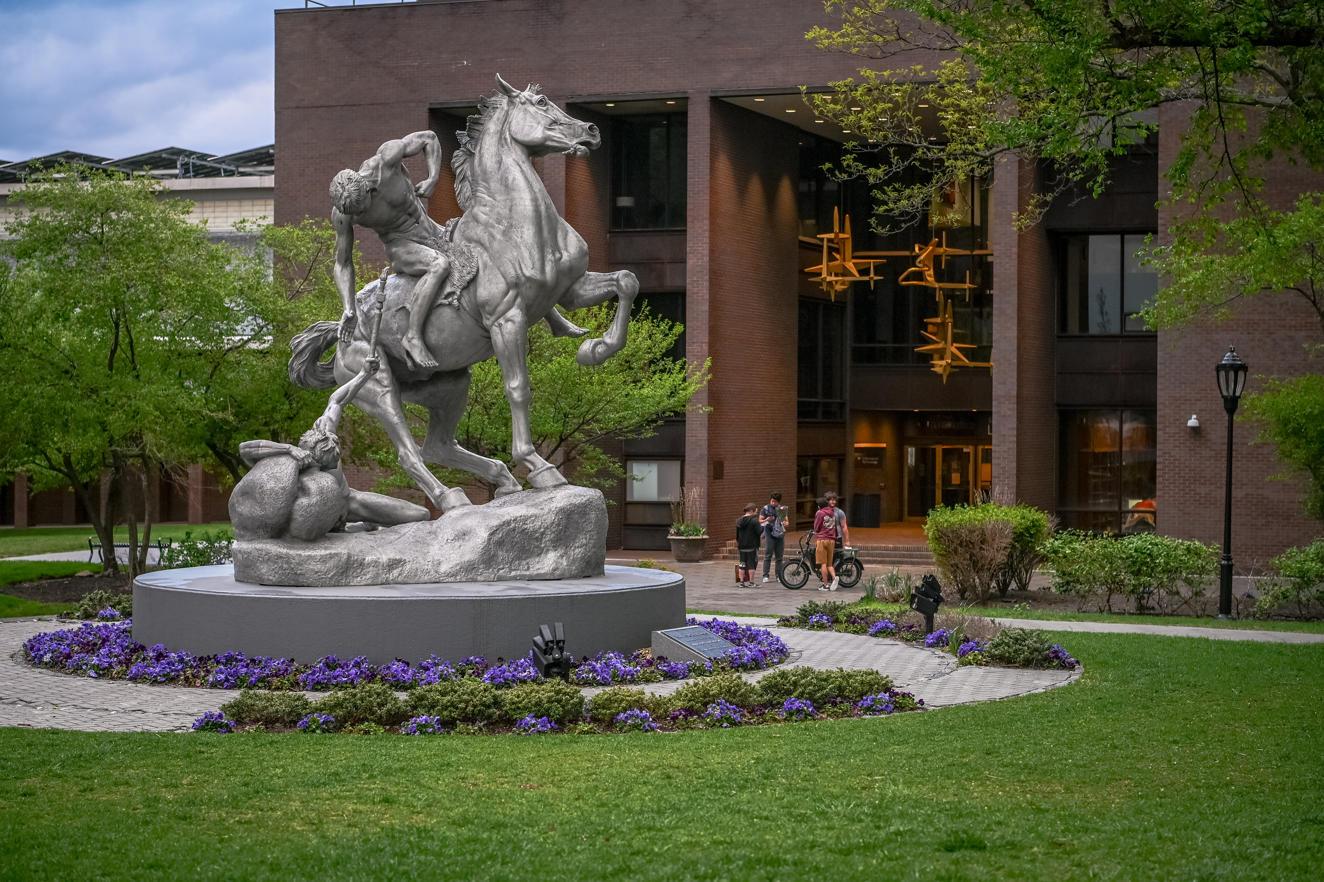 Torchbearers statue on campus in front of the library