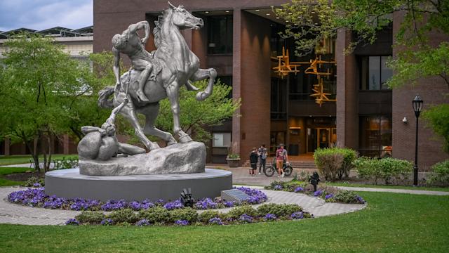 Torchbearers statue on campus in front of the library