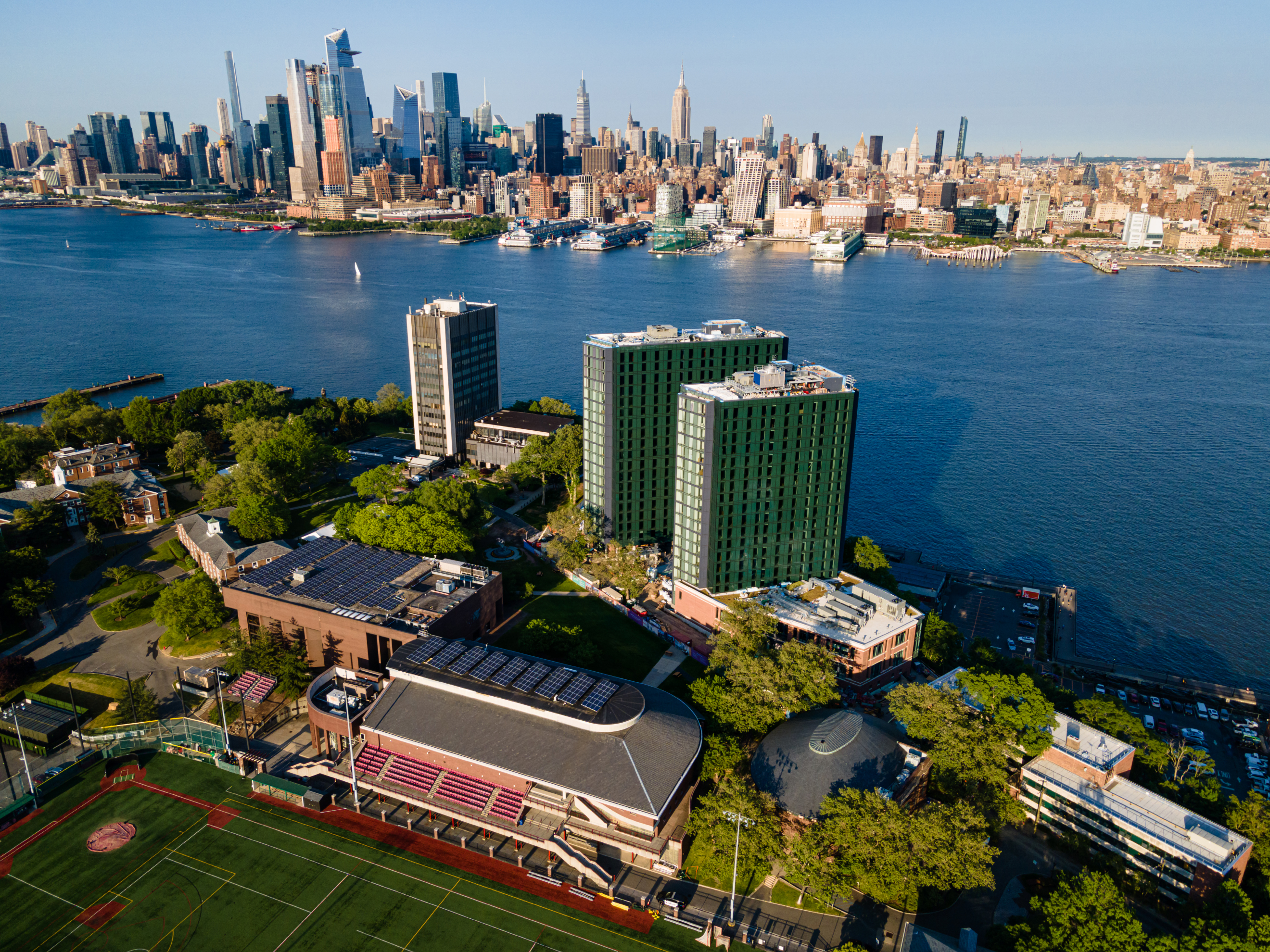 Aerial image of Stevens campus with New York skyline in background.