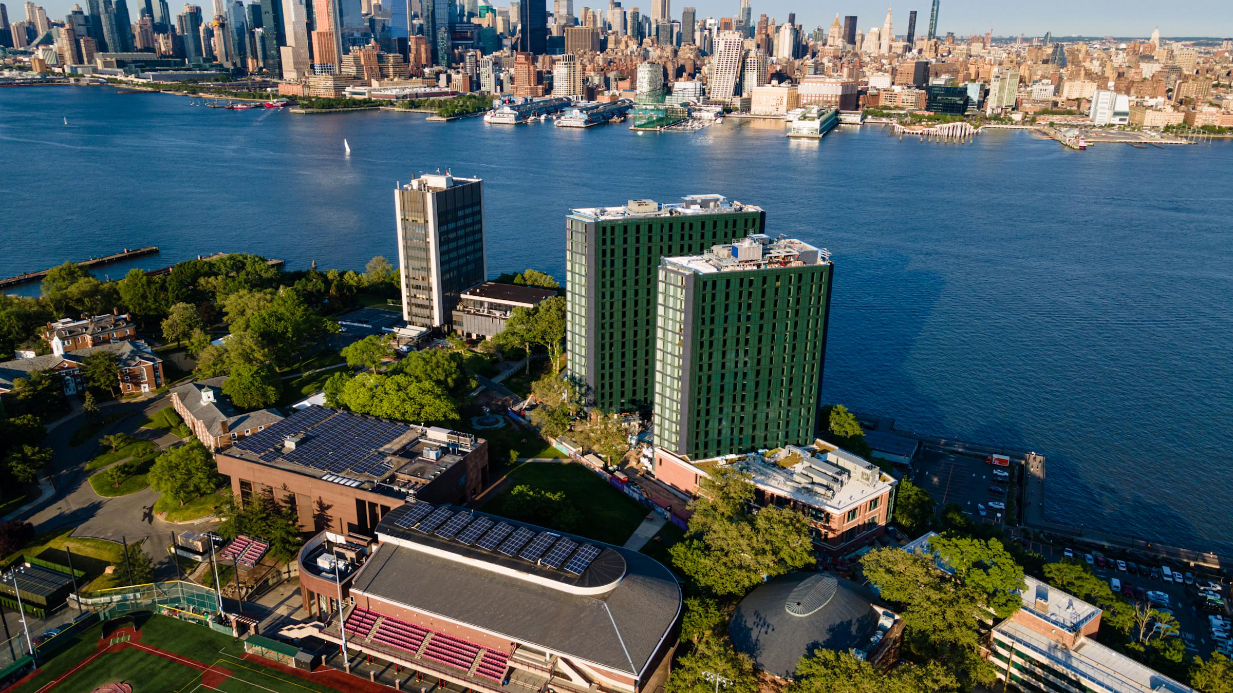 Aerial image of Stevens campus with New York skyline in background.