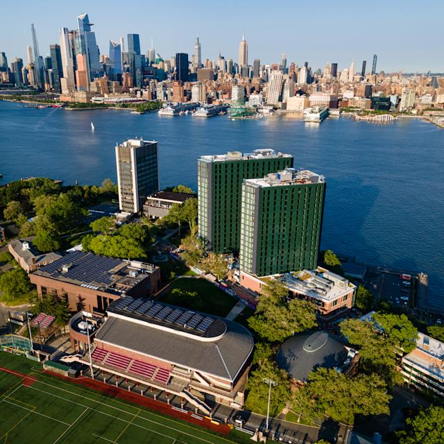 Aerial image of Stevens campus with New York skyline in background.