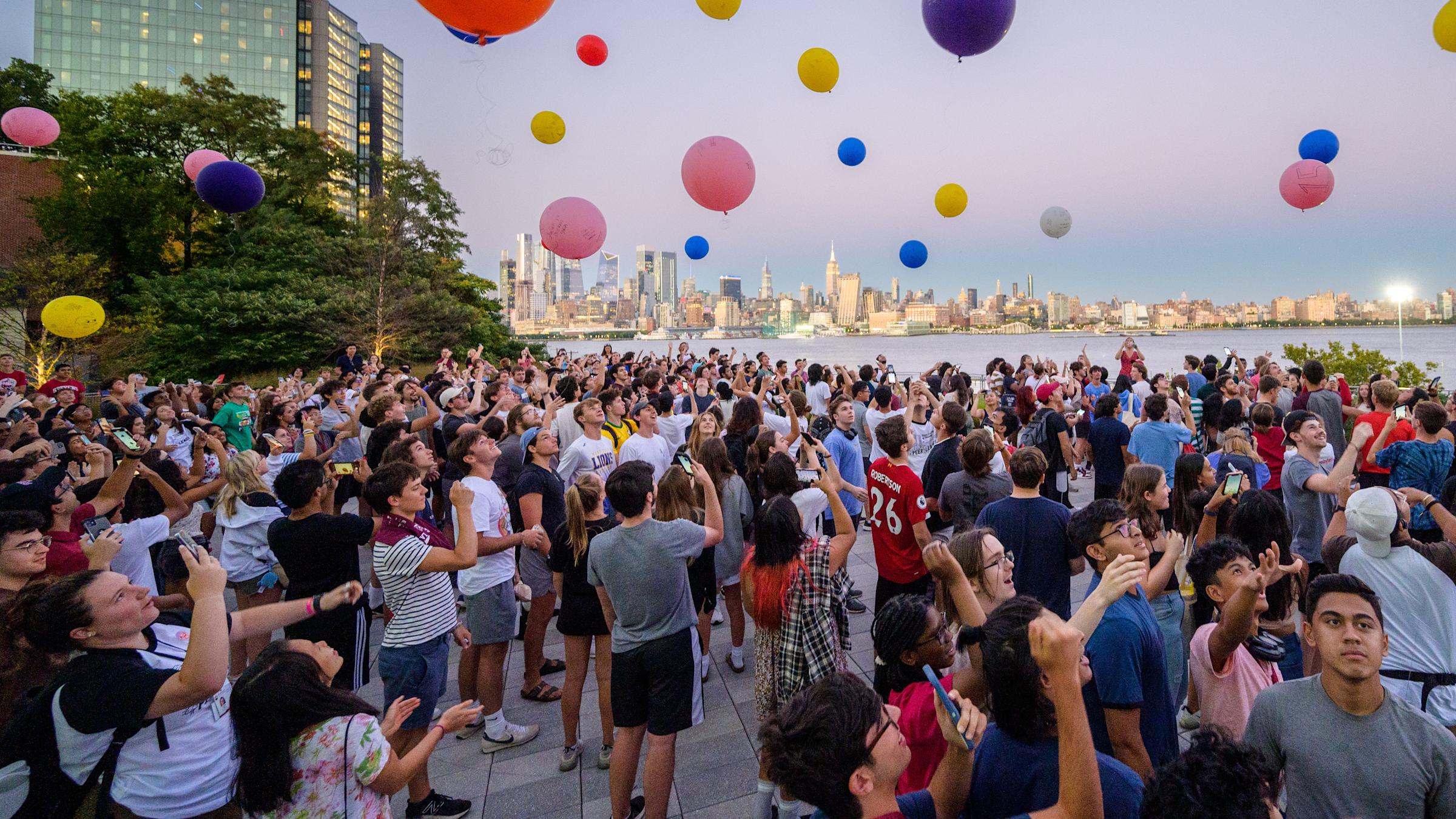 Stevens students on the Babbio patio launching balloons
