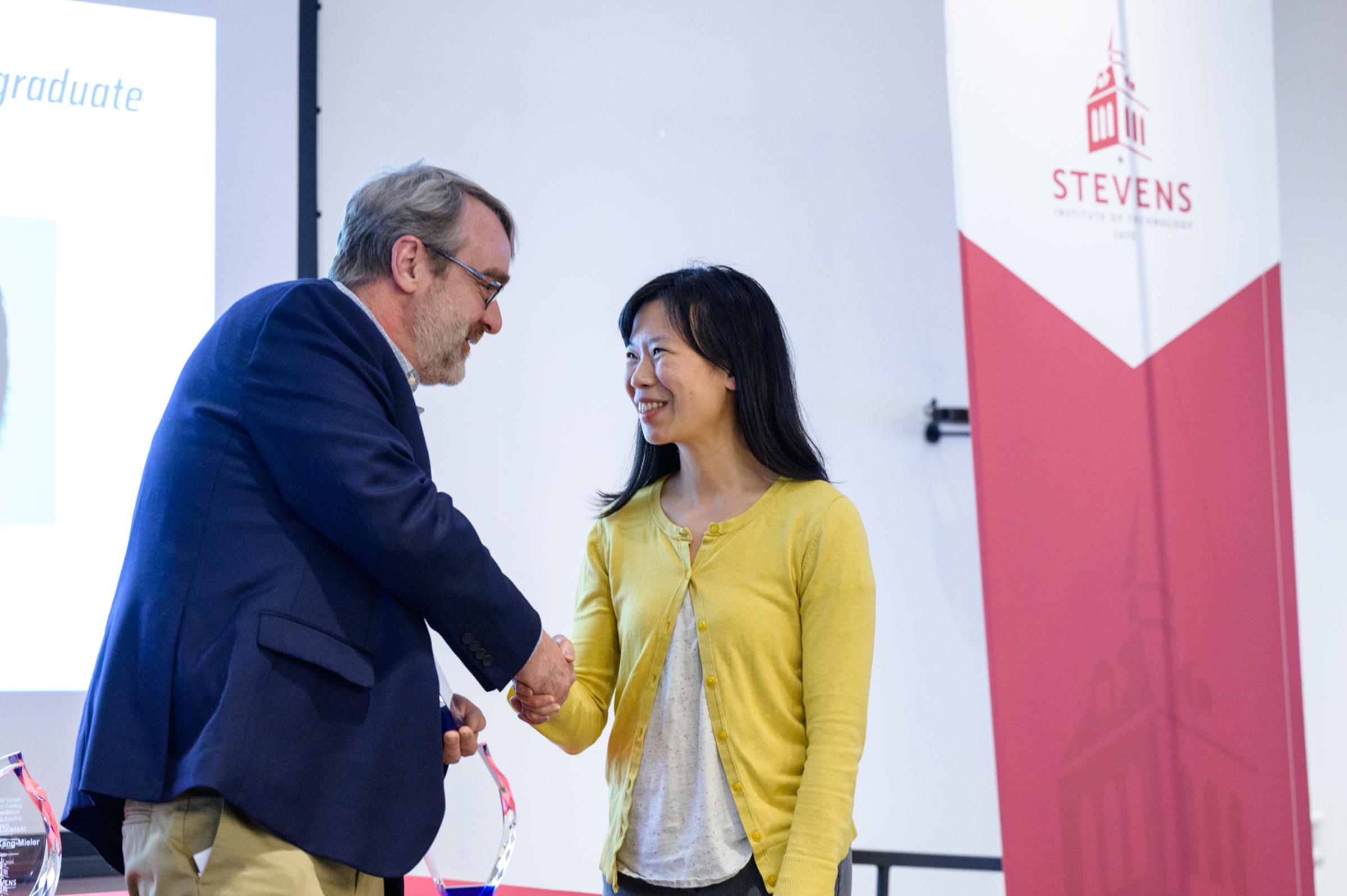 Frank Fisher shaking hands with Maxine Fontaine