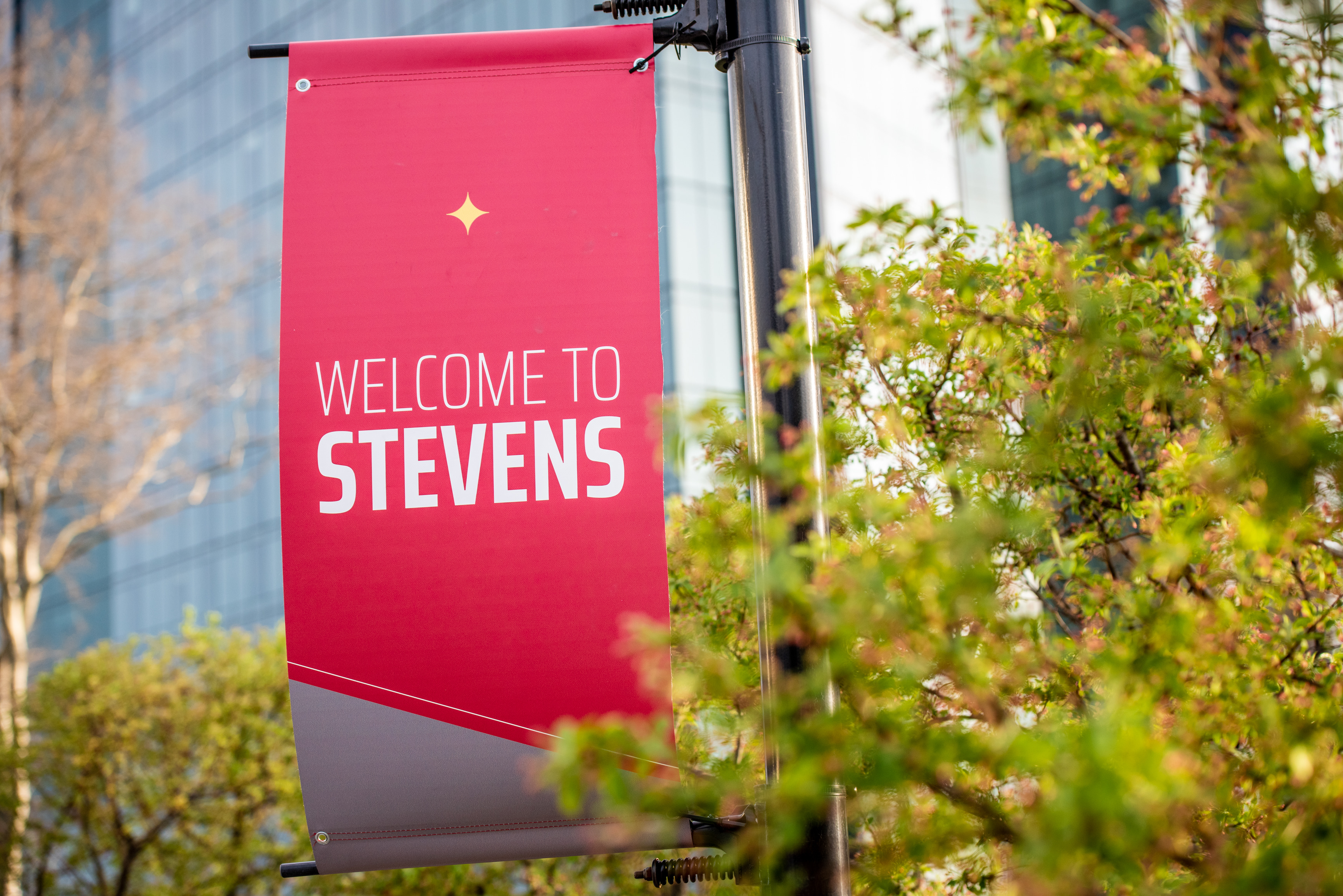 Welcome to Stevens light pole banner with University Center Complex in background