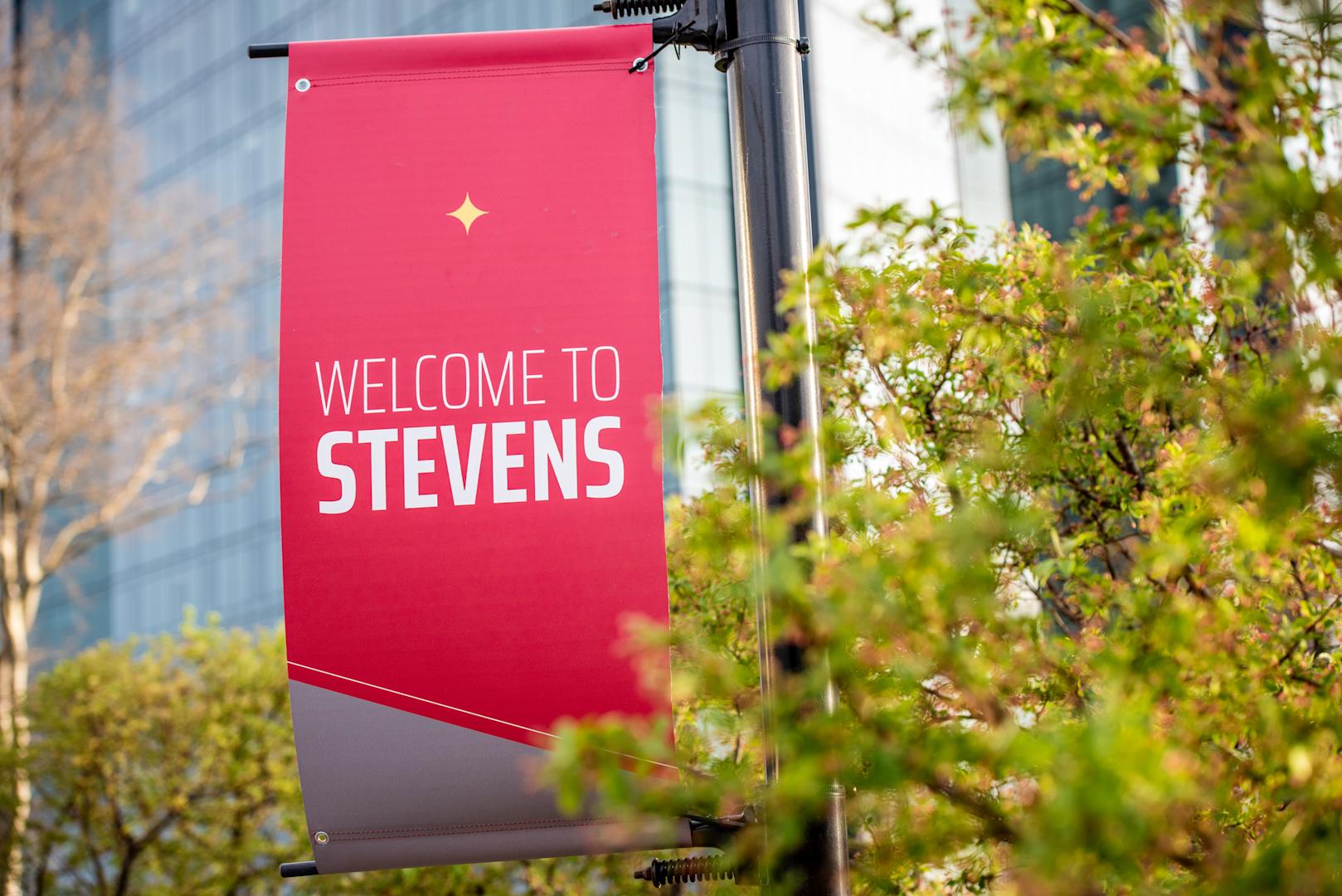 Welcome to Stevens light pole banner with University Center Complex in background