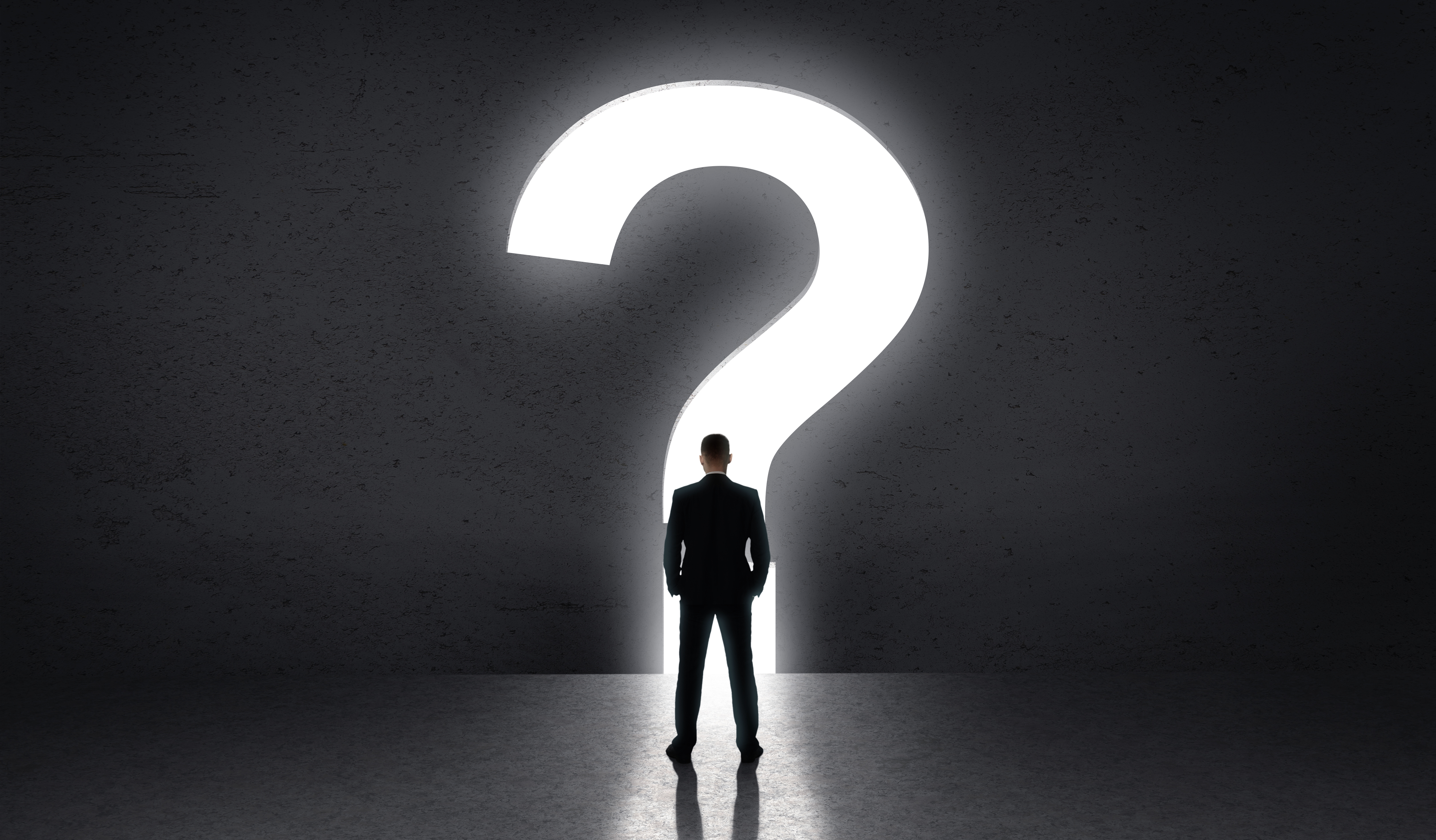 Person standing in front of large question mark