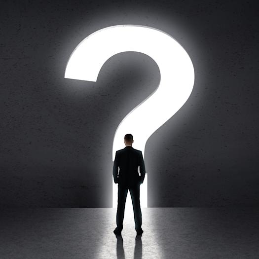 Person standing in front of large question mark