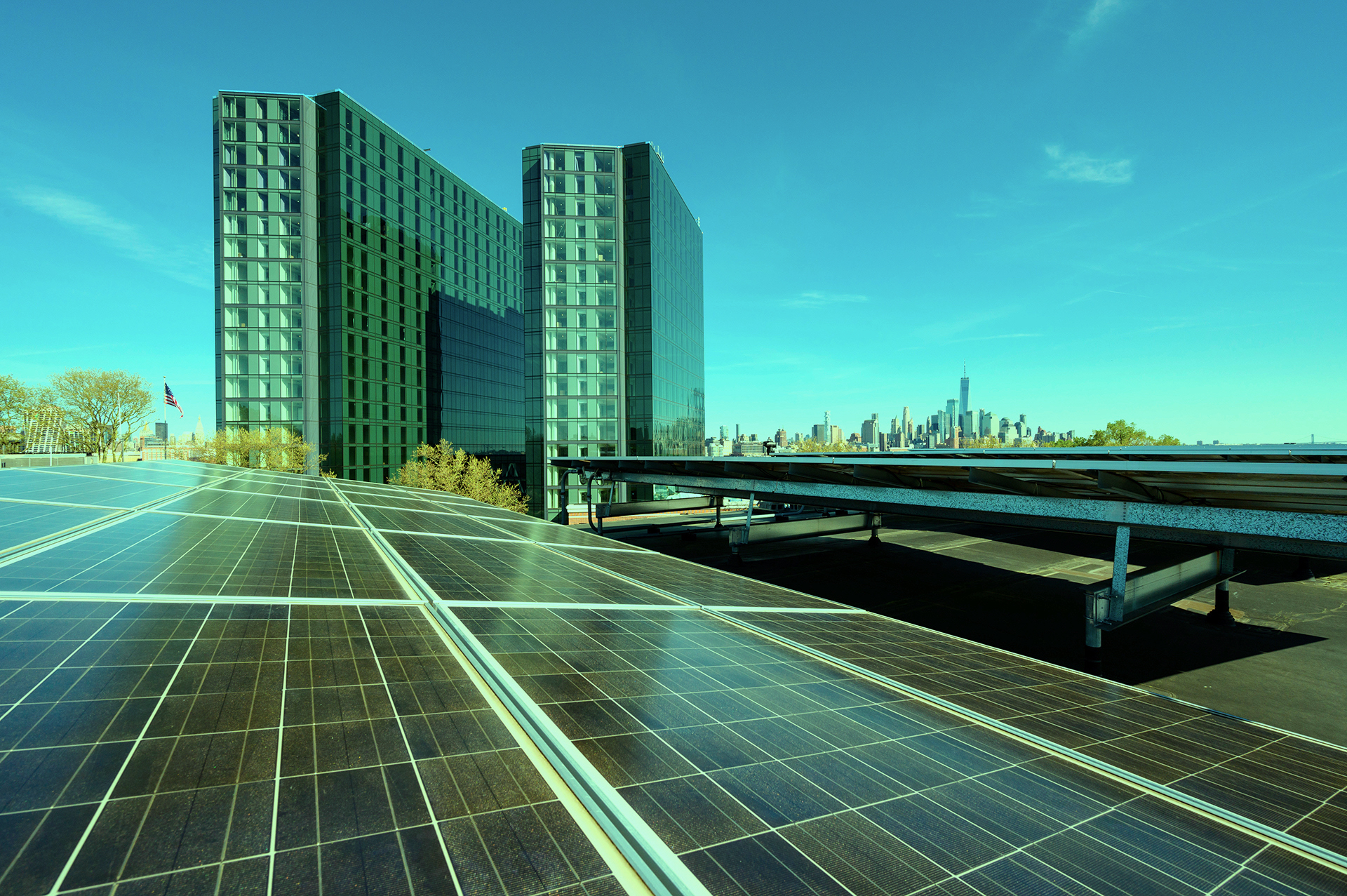Solar panels on rooftop on Stevens campus, with NYC skyline behind