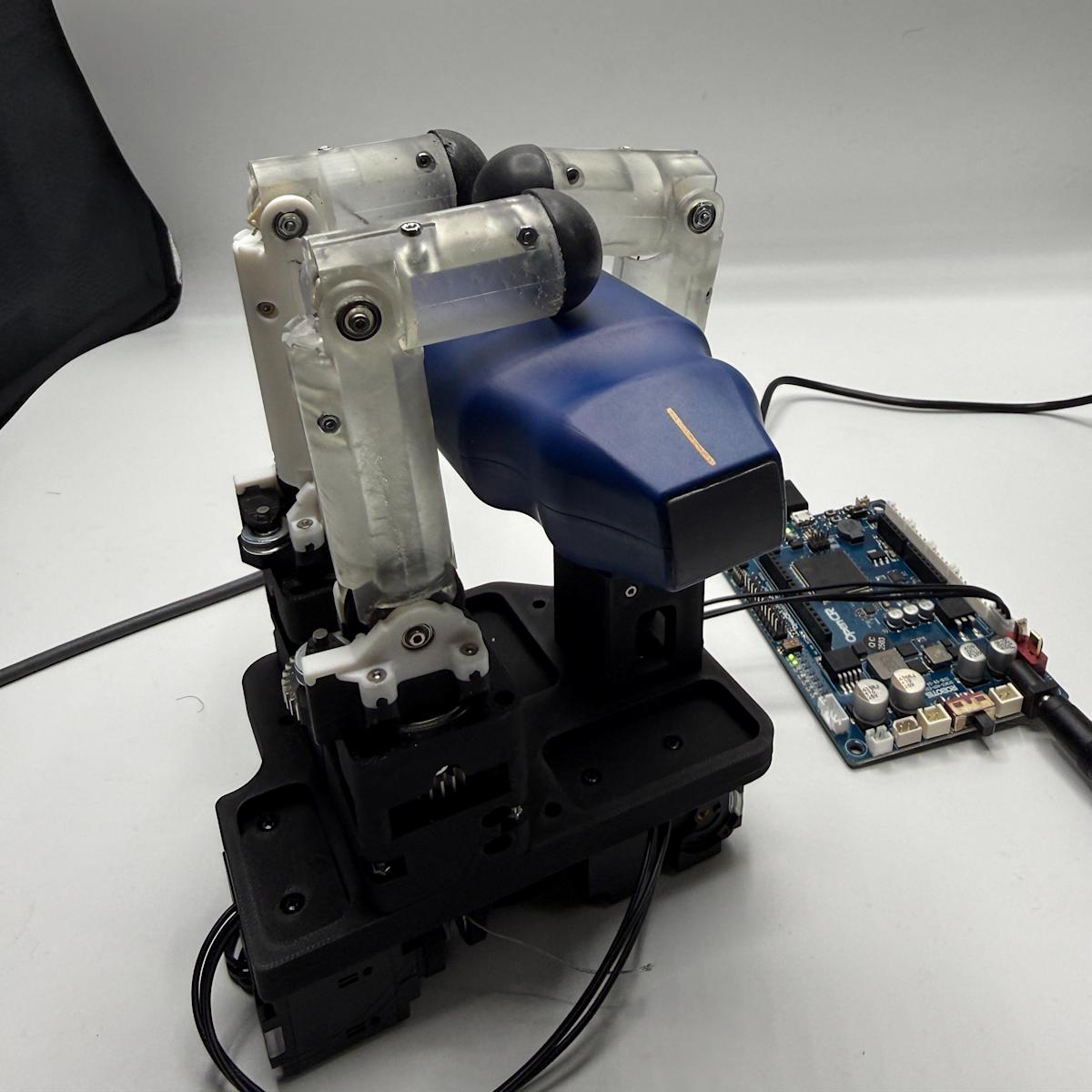 The robotic hand performs a preliminary grasp of an ultrasound probe, demonstrating one of the project’s target medical-use scenarios for casualty care and trauma assessment.