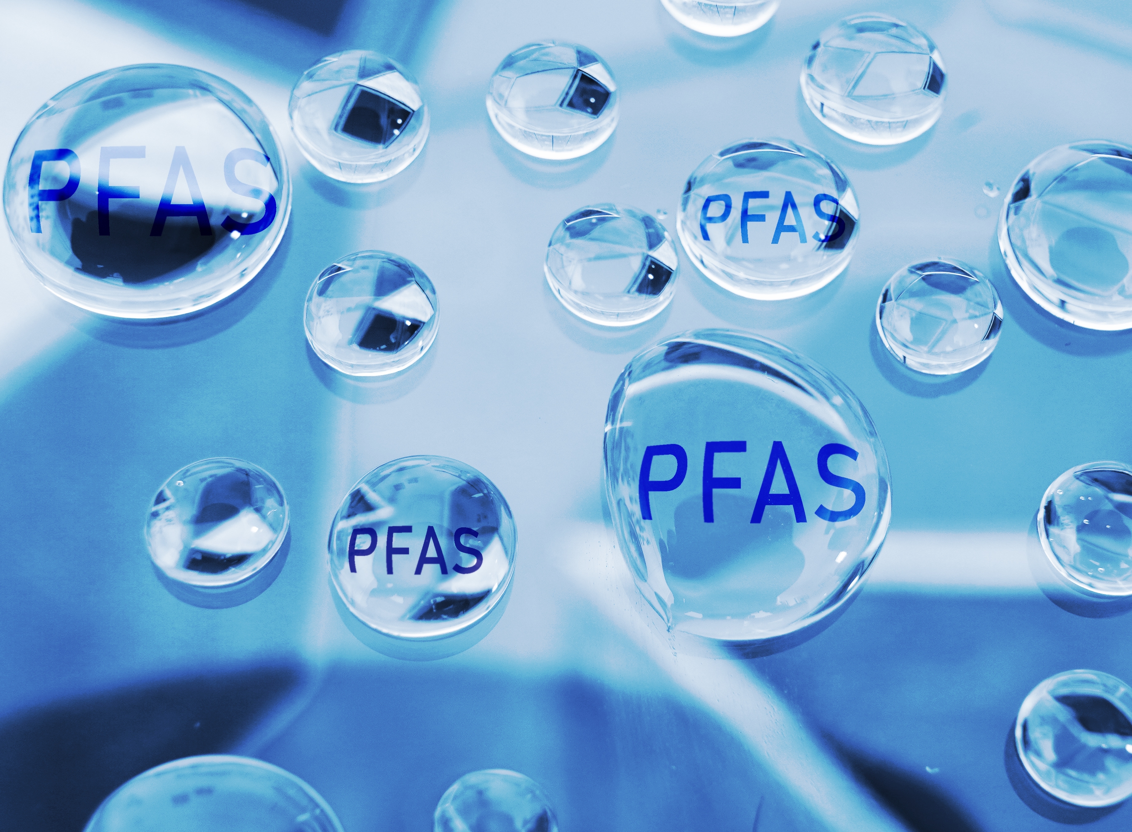 Water drops with "PFAS" written inside them