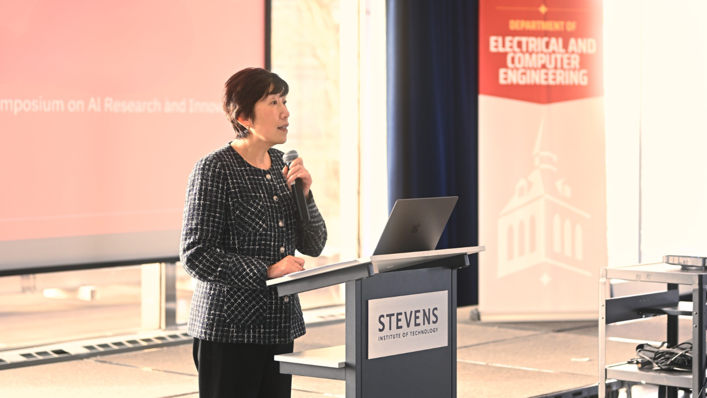 Schaefer School of Engineering and Science Lori E. Feiler Dean Jean Zu speaking at a Stevens podium.