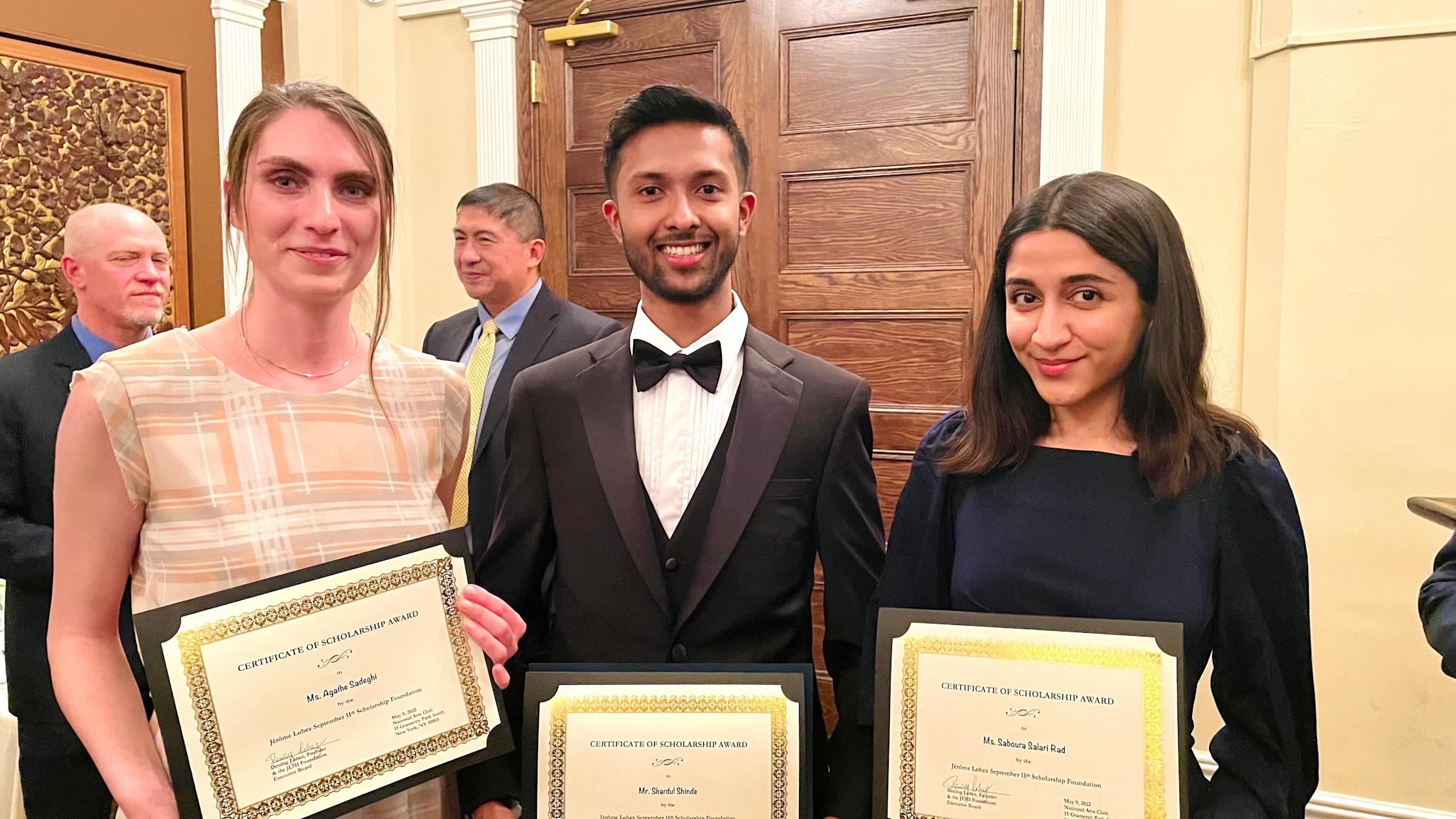 Shardule Shinde holding his certificate of scholarship from the Jerome Lohez 9/11 Scholarship Foundation. He is in the middle of two other recipients.