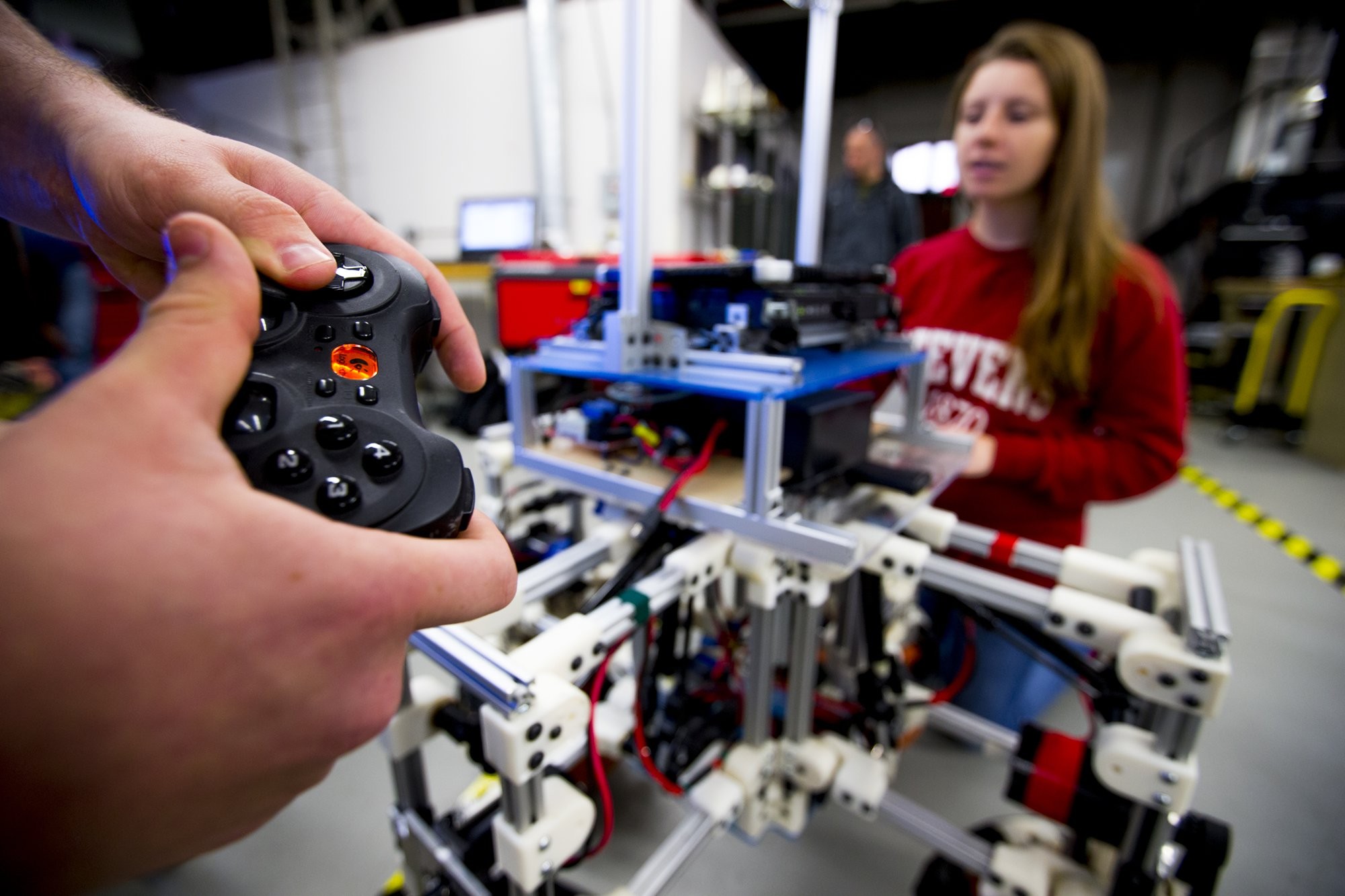 A closeup of students using remote controls