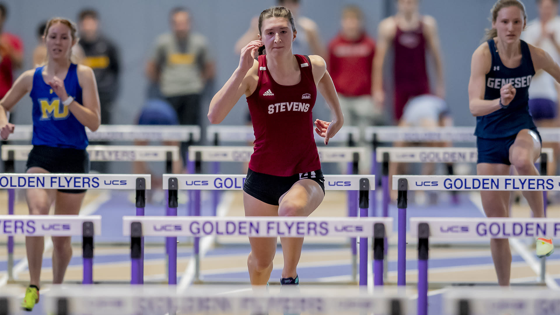 Laura Mathews ahead of two competitors in indoor hurdles.