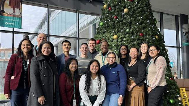 A group of alumni gather and smile for a photo during the alumni workplace engagement program