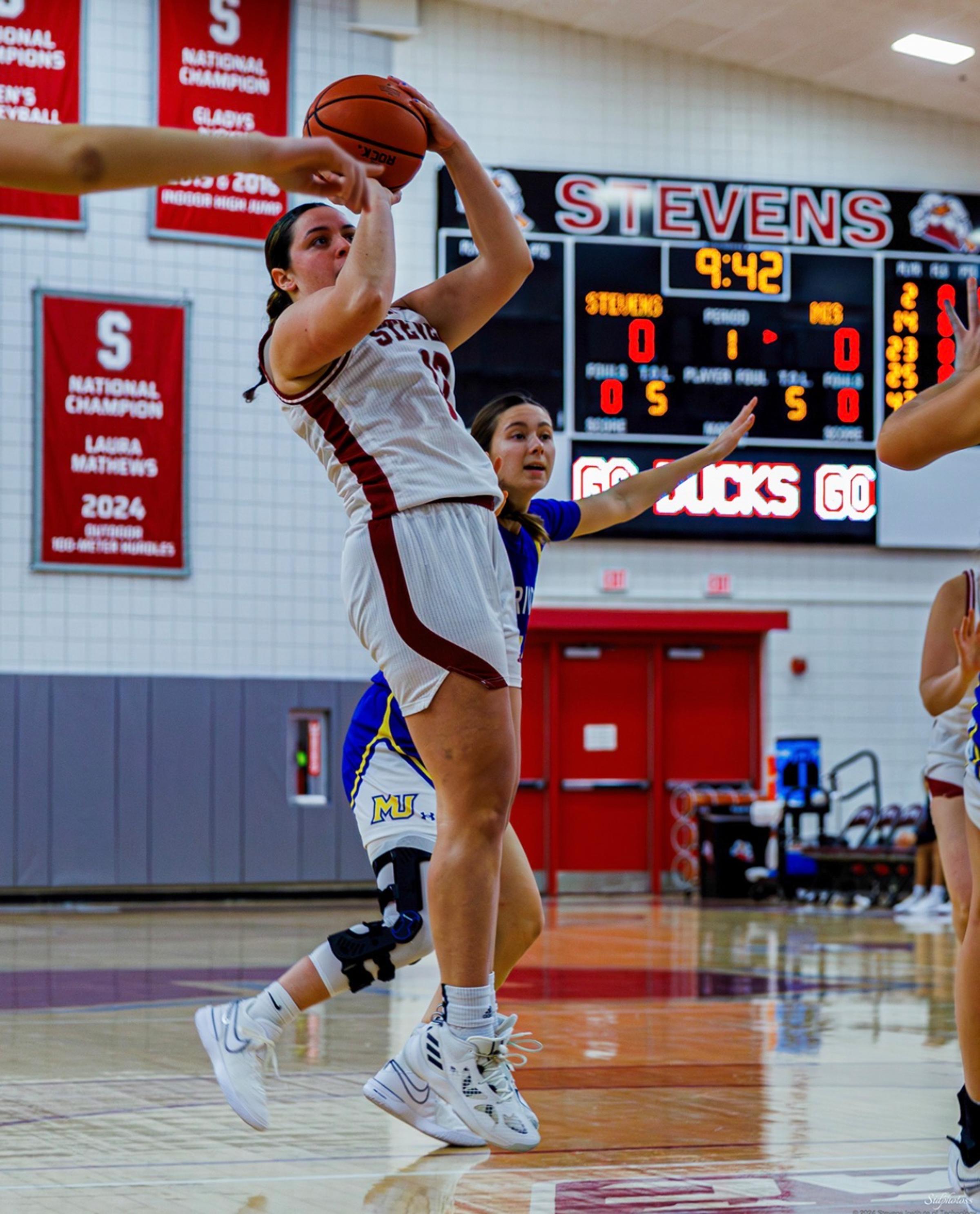Dorothy Loffredo shoots the ball during a basketball game
