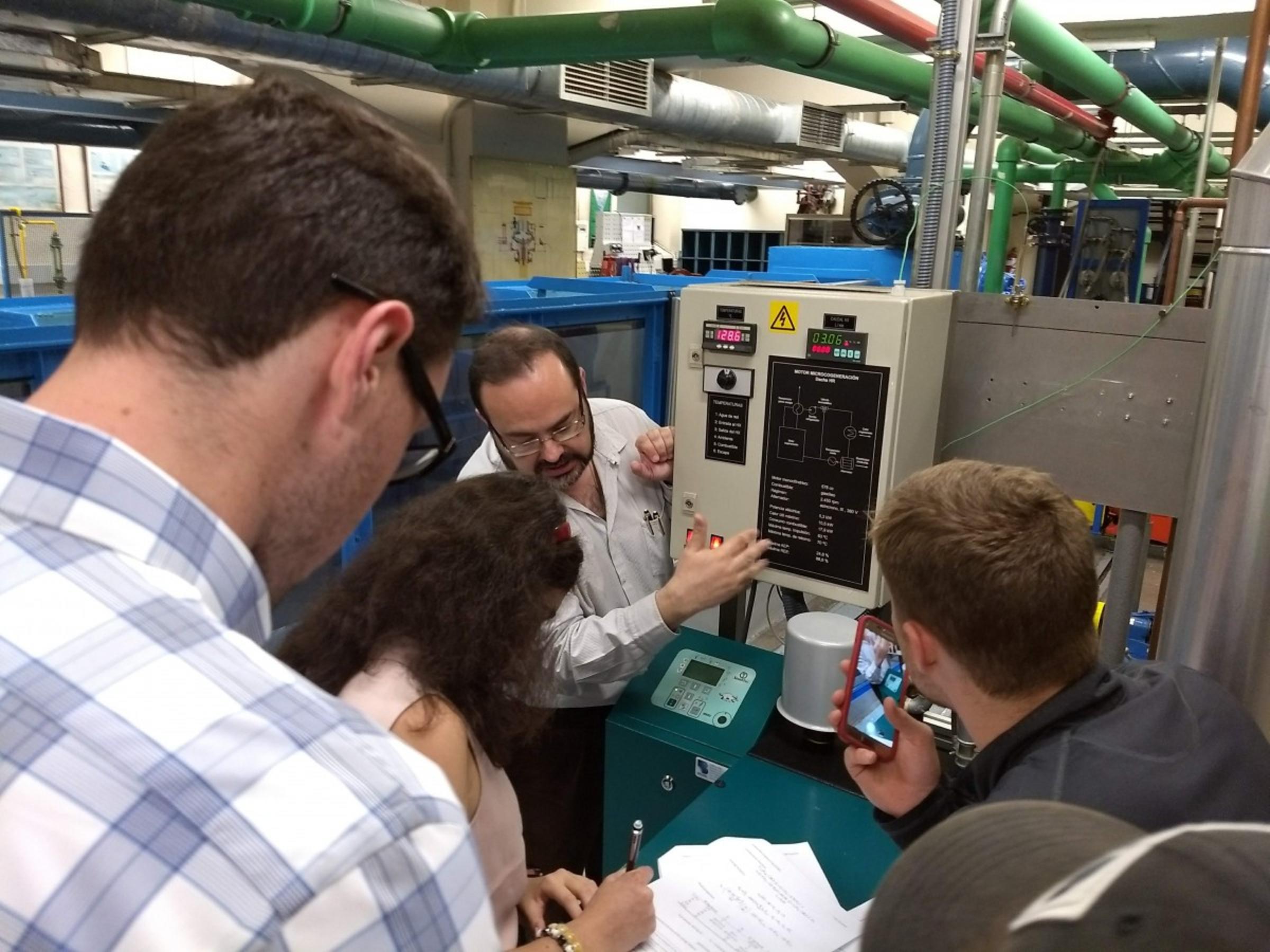 Students Liam McAlister, Chana Meystelman and Jonas lackey learn about research in Comillas professor Jose Ignacio’s lab. CREDIT: Ron Besser