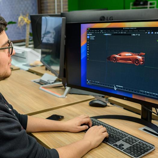 Male student working on a car design on a computer