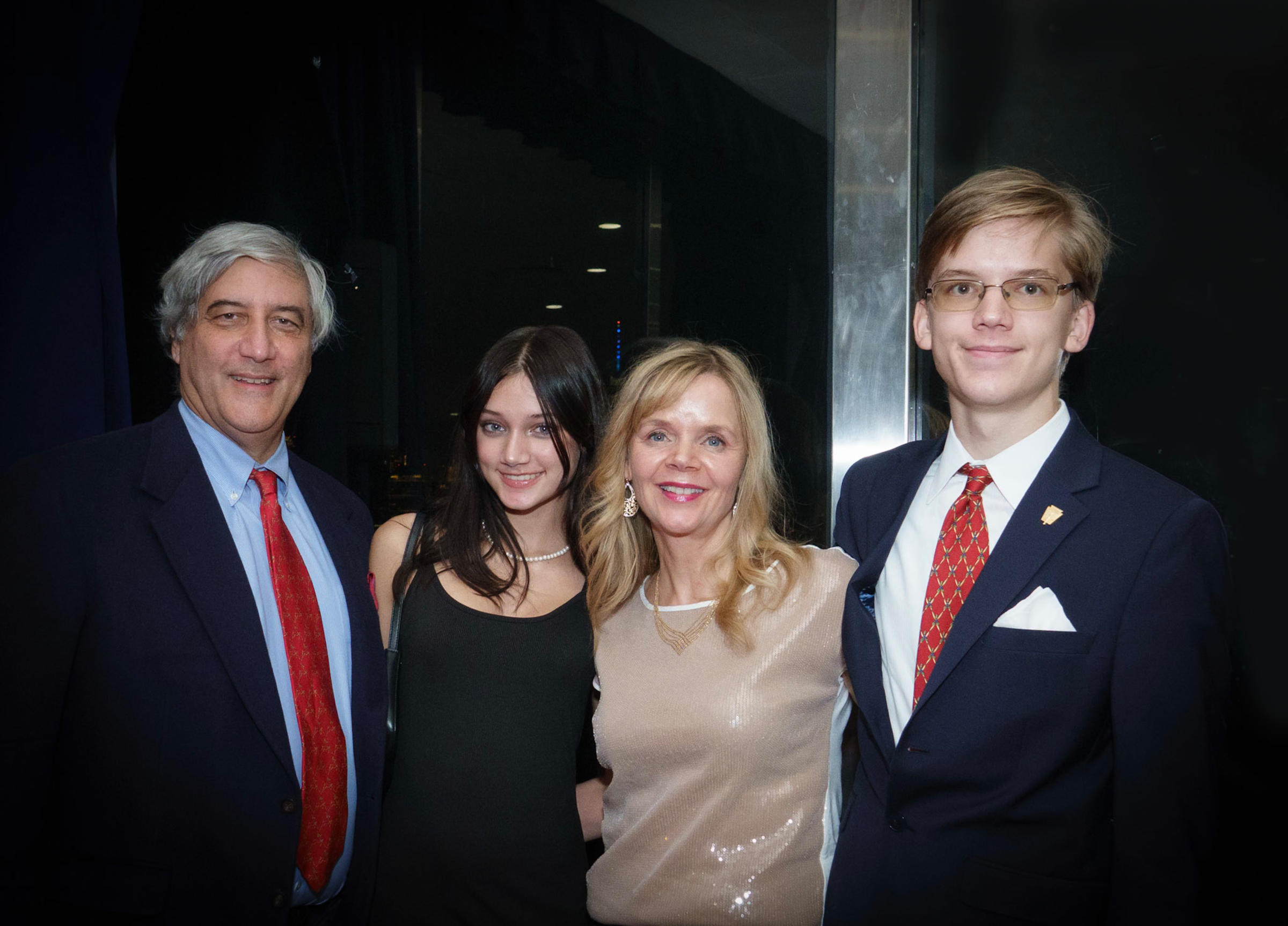 Photo of four people: Bose's son and his family