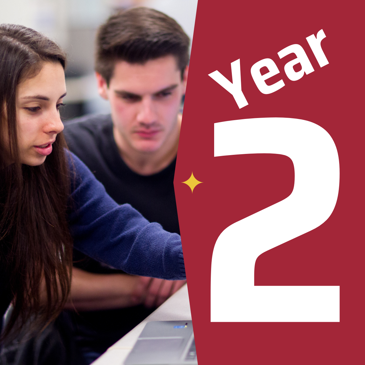 a female student in a computer lab pointing at a laptop screen as a male student looks on in the background next to a graphic that says year two.